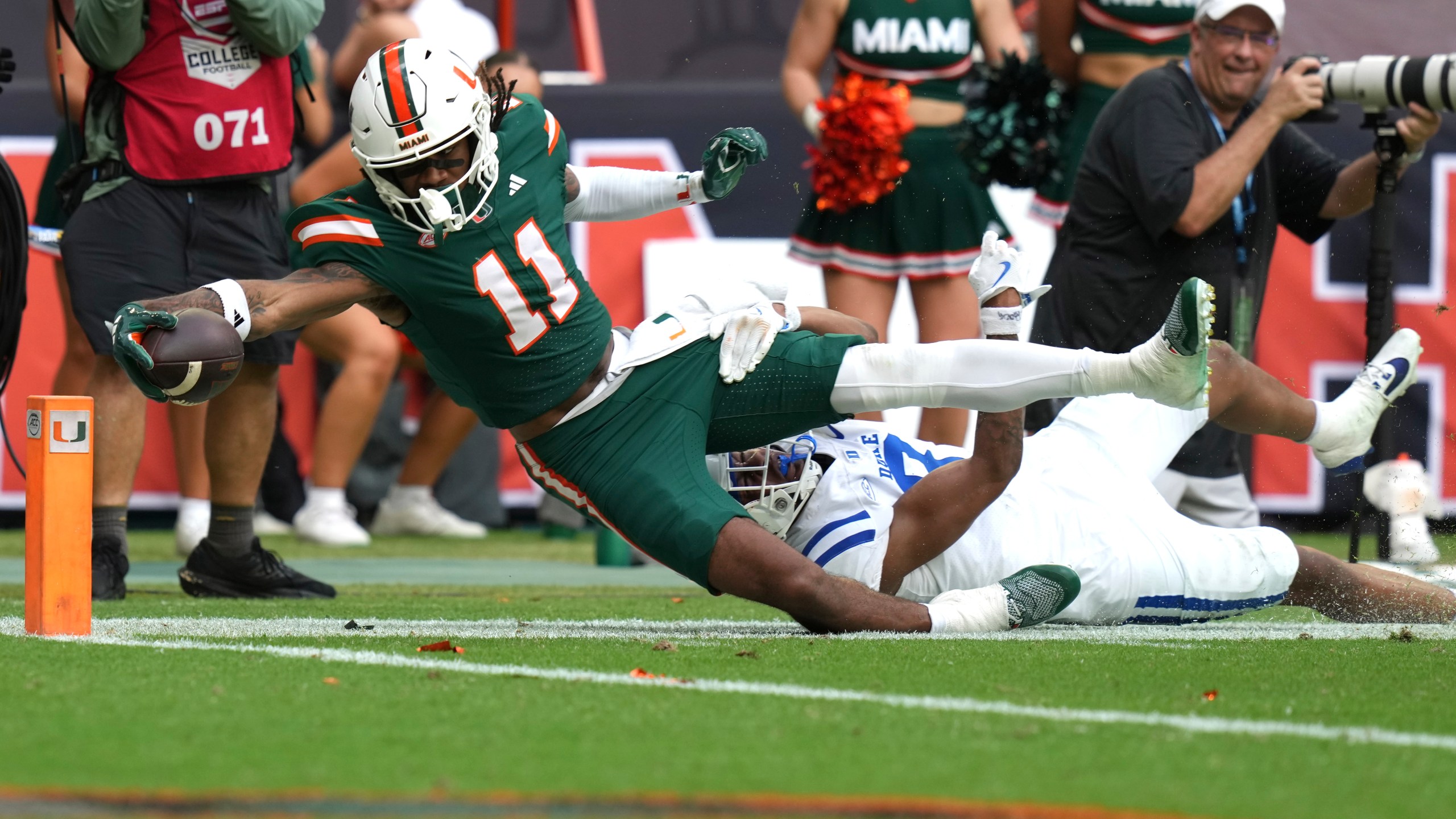 Miami wide receiver Samuel Brown (11) is stopped short of the goal line for a first down as Duke safety DaShawn Stone, right, defends during the second half of an NCAA college football game, Saturday, Nov. 2, 2024, in Miami Gardens, Fla. (AP Photo/Lynne Sladky)