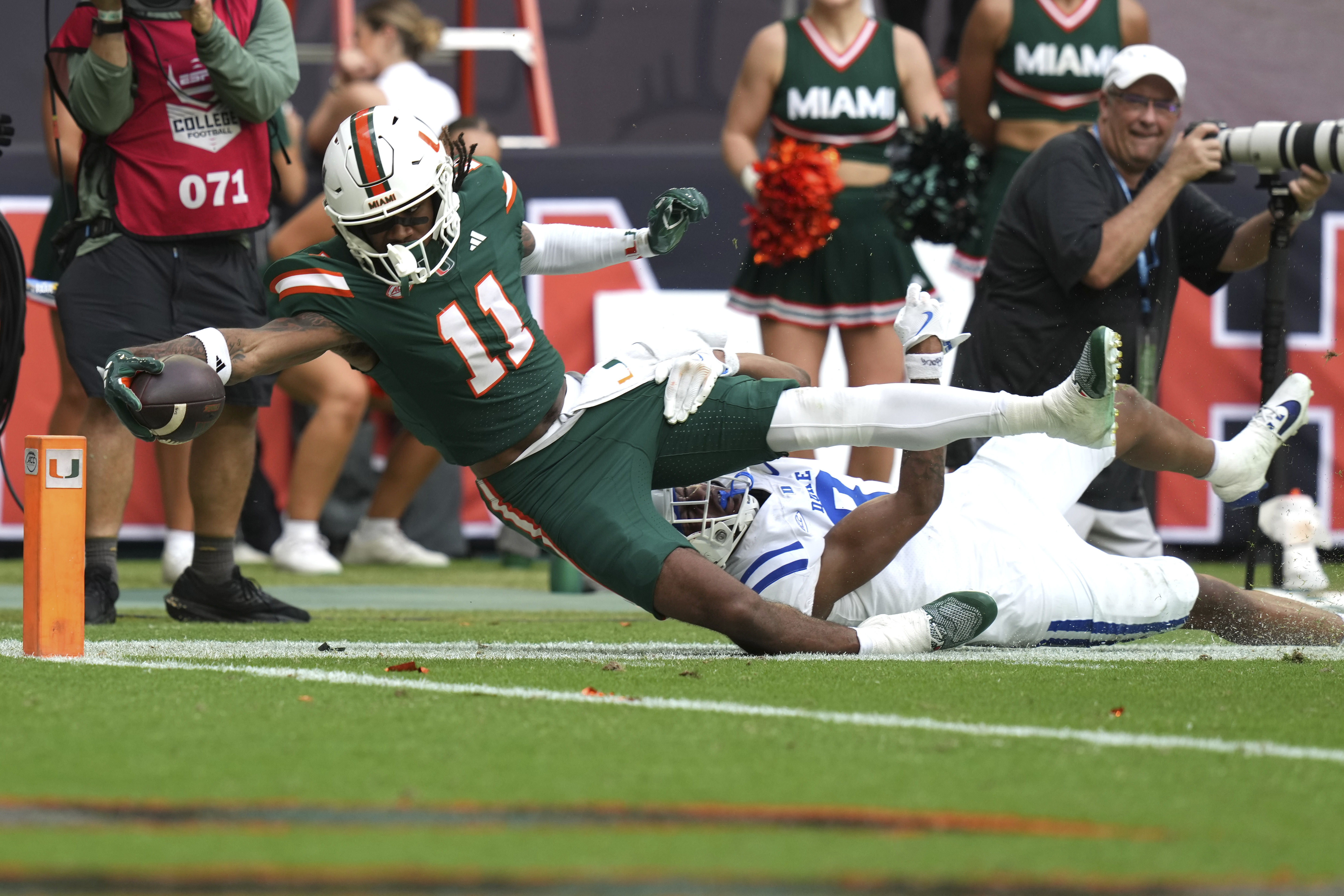 Miami wide receiver Samuel Brown (11) is stopped short of the goal line for a first down as Duke safety DaShawn Stone, right, defends during the second half of an NCAA college football game, Saturday, Nov. 2, 2024, in Miami Gardens, Fla. (AP Photo/Lynne Sladky)