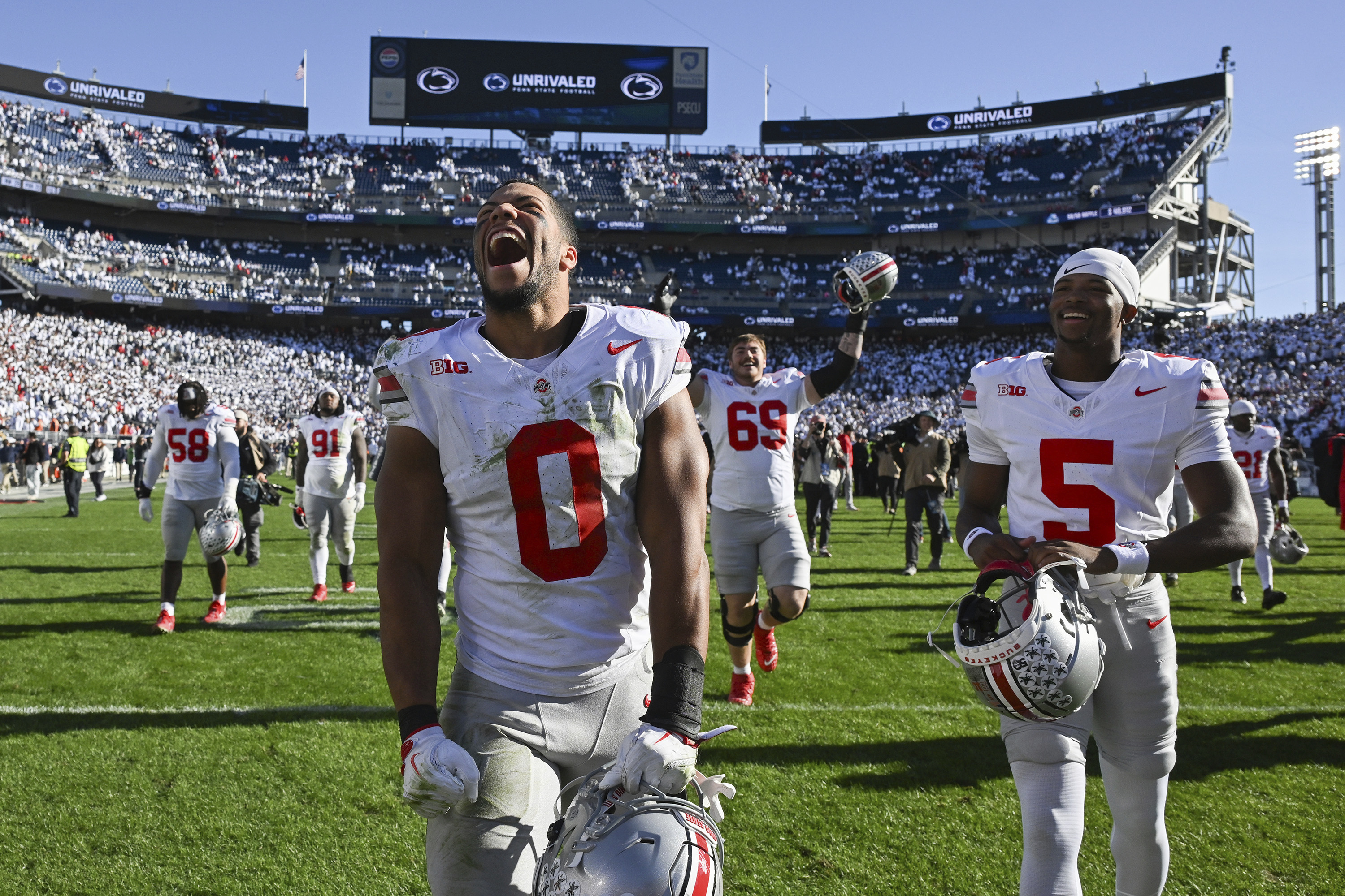 Ohio State linebacker Cody Simon (0) celebrates after defeating Penn State 20-13 in an NCAA college football game, Saturday, Nov. 2, 2024, in State College, Pa. (AP Photo/Barry Reeger)