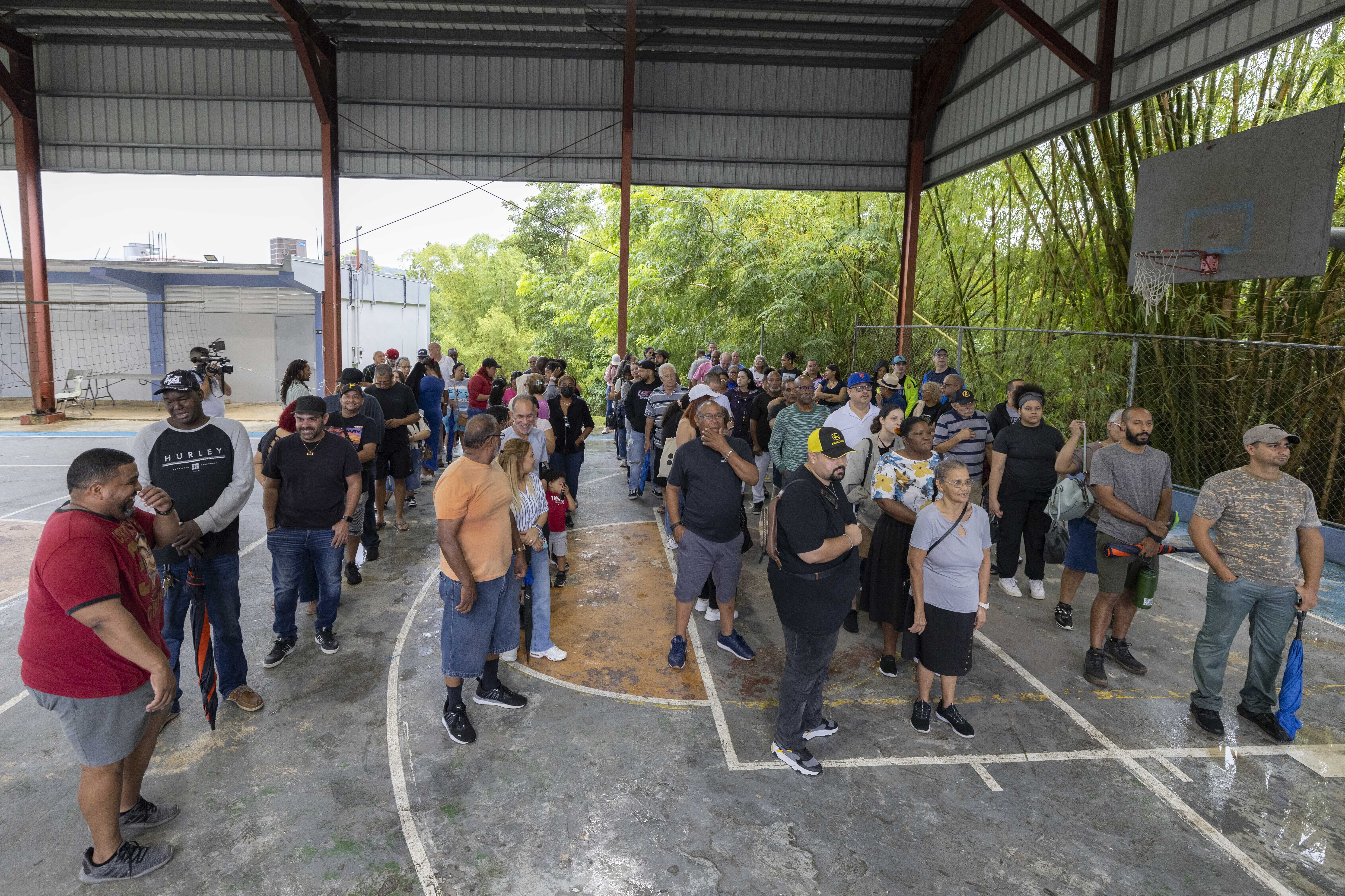 Voters line up at a polling station during general elections in San Juan, Puerto Rico, Tuesday, Nov. 5, 2024. (AP Photo/Alejandro Granadillo)