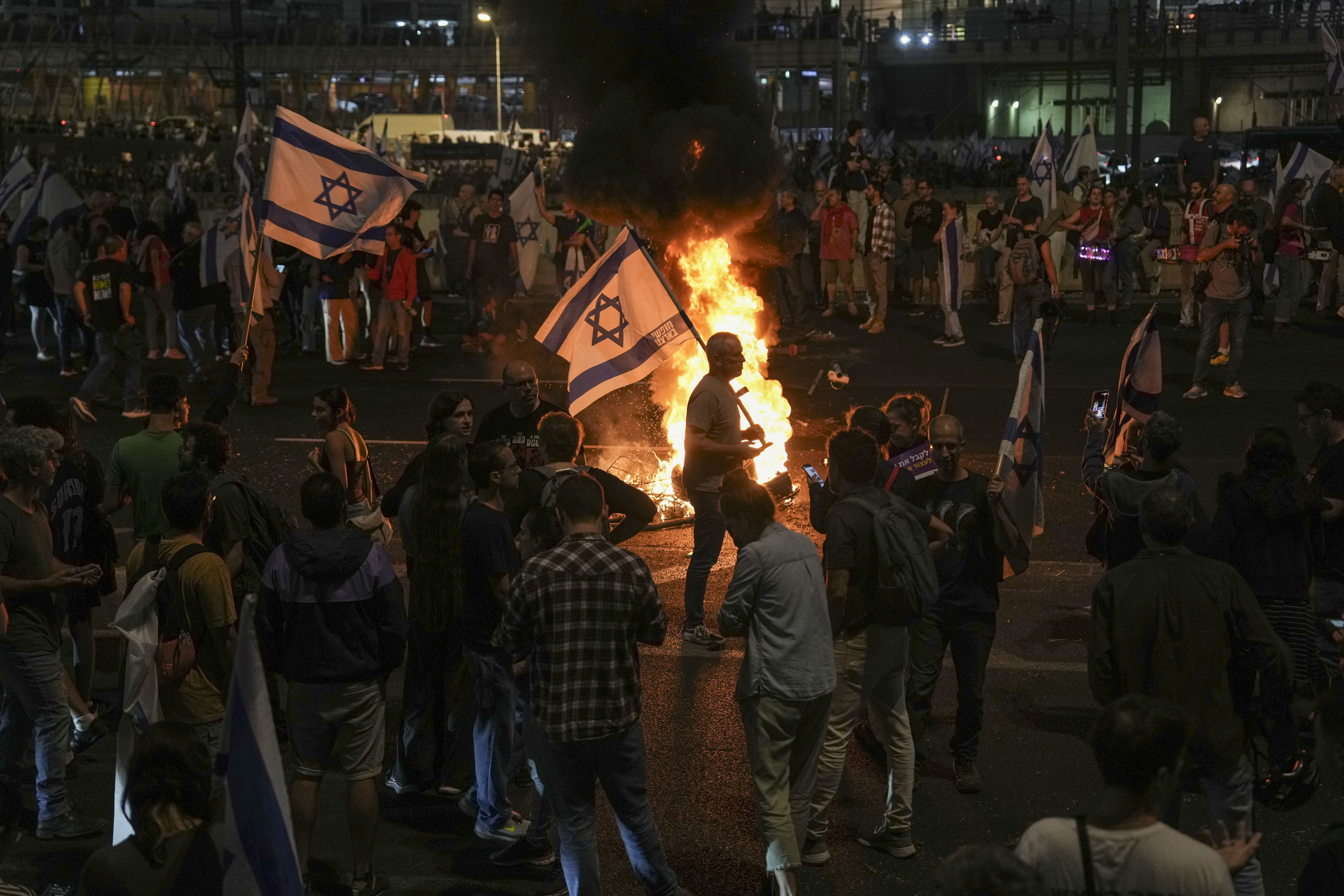 Israelis light a bonfire during a protest after Prime Minister Benjamin Netanyahu has dismissed his defense minister Yoav Gallant in a surprise announcement in Tel Aviv, Israel, Tuesday, Nov. 5, 2024. (AP Photo/Oded Balilty)