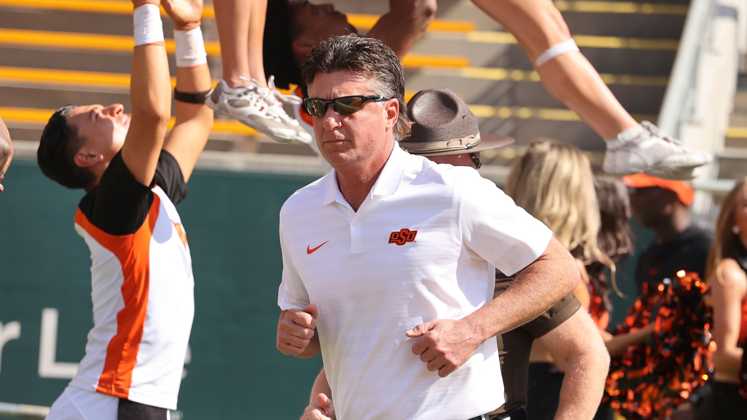 Oklahoma State head coach Mike Gundy runs on the field before an NCAA college football game against Baylor, Saturday, Oct. 26, 2024, in Waco, Texas. (Rod Aydelotte/Waco Tribune-Herald via AP)