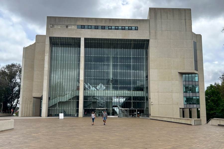 FILE - People walk outside the High Court building in Canberra, Australia, on Nov. 23, 2023. (AP Photo/Rod McGuirk, File)