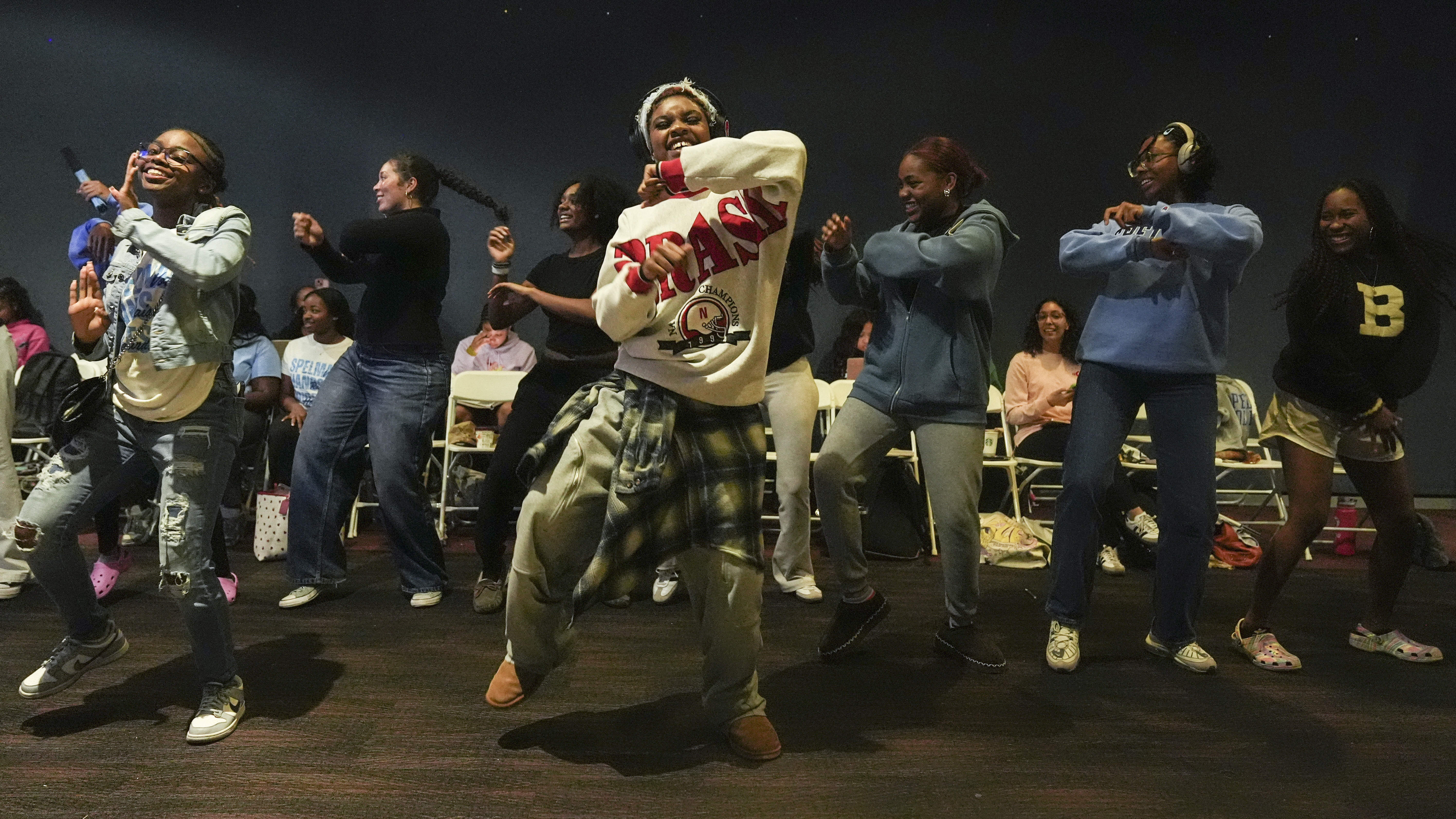 Students dance as they watch election coverage at Spelman College, Tuesday, Nov. 5, 2024, in Atlanta. (AP Photo/Brynn Anderson)