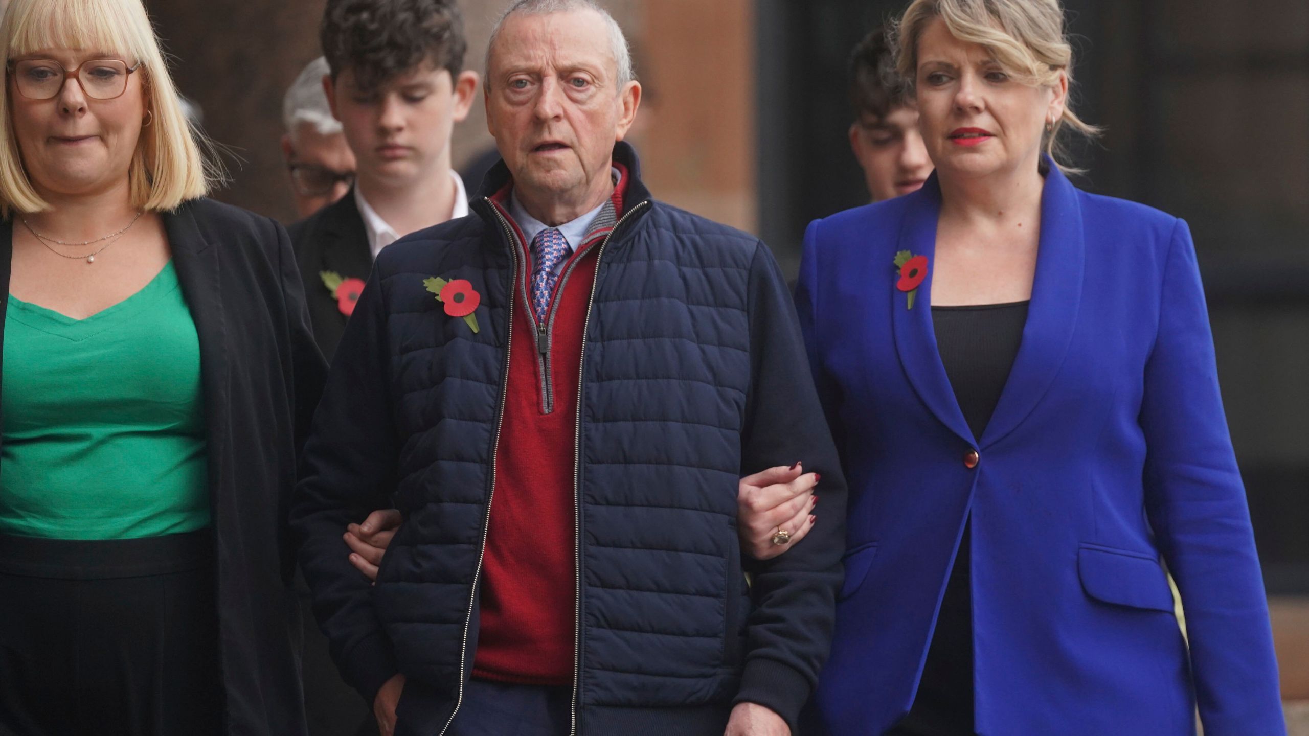 Patrick O'Hara, center, and family members leave Newcastle Crown Court, in Newcastle, England, Wednesday, Nov. 6, 2024 where Dr. Thomas Kwan, was sentenced to 31 years and five months after he attempted to murder Mr O'Hara, who was his mother's partner, with a poisoned fake Covid jab whilst disguised as a nurse. (Owen Humphreys/PA via AP)