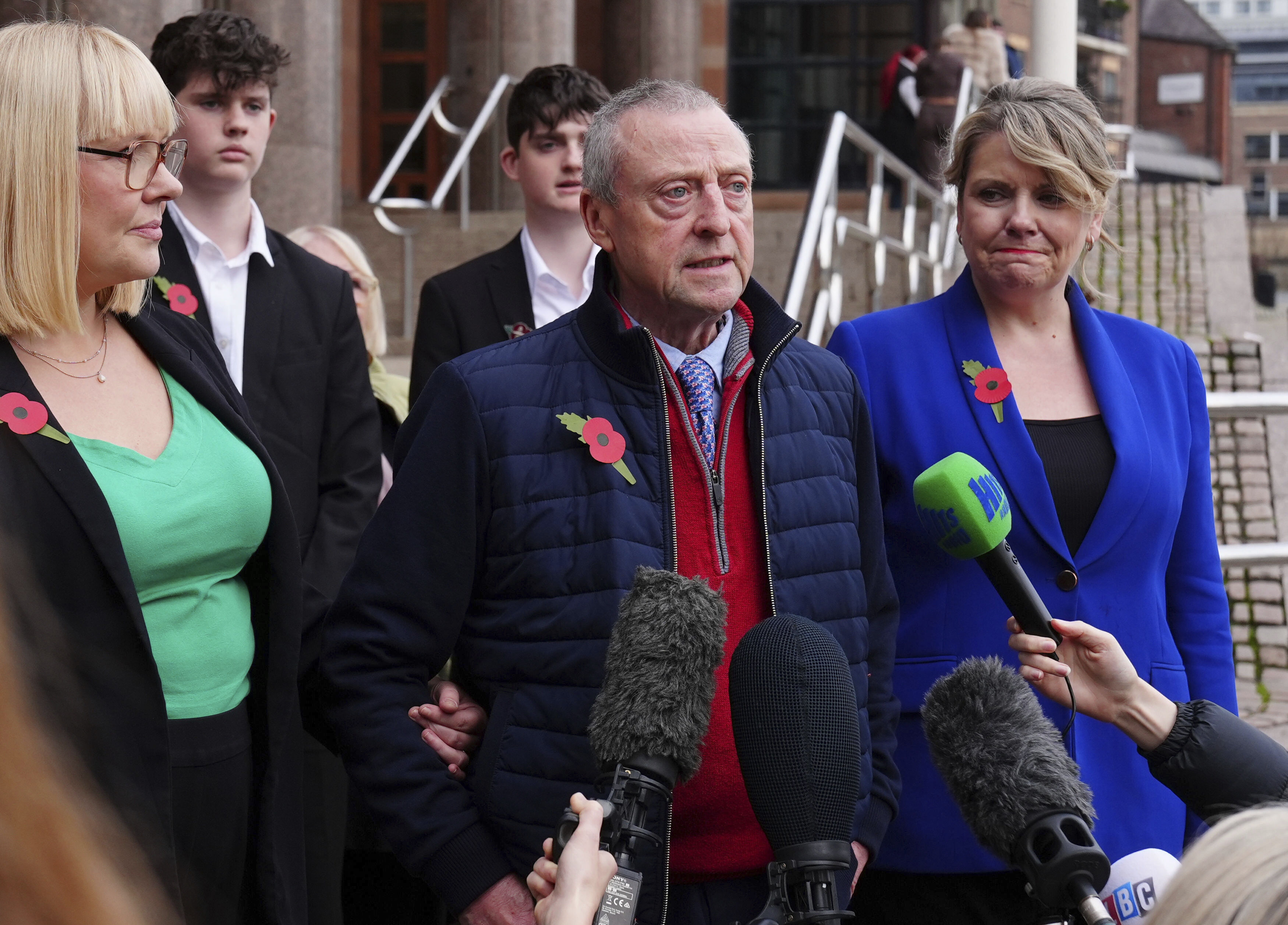 Patrick O'Hara, center, talks to the media outside the Newcastle Crown Court, in Newcastle, England, Wednesday, Nov. 6, 2024 where Dr. Thomas Kwan, was sentenced to 31 years and five months after he attempted to murder Mr O'Hara, who was his mother's partner, with a poisoned fake Covid jab whilst disguised as a nurse. (Owen Humphreys/PA via AP)