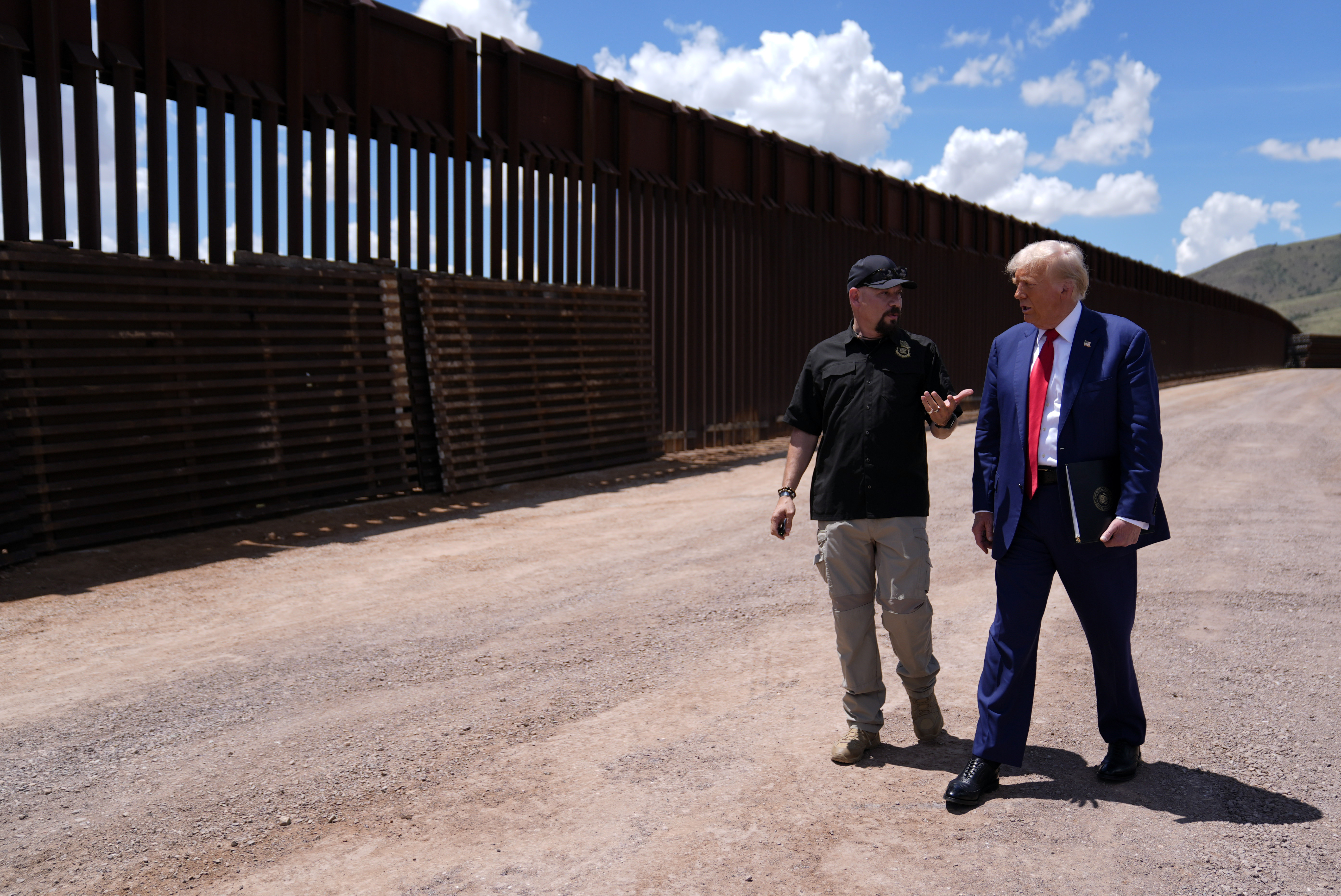 FILE - Republican presidential nominee former President Donald Trump listens to Paul Perez, president of the National Border Patrol Council, as he tours the southern border with Mexico, on Aug. 22, 2024, in Sierra Vista, Ariz. (AP Photo/Evan Vucci)