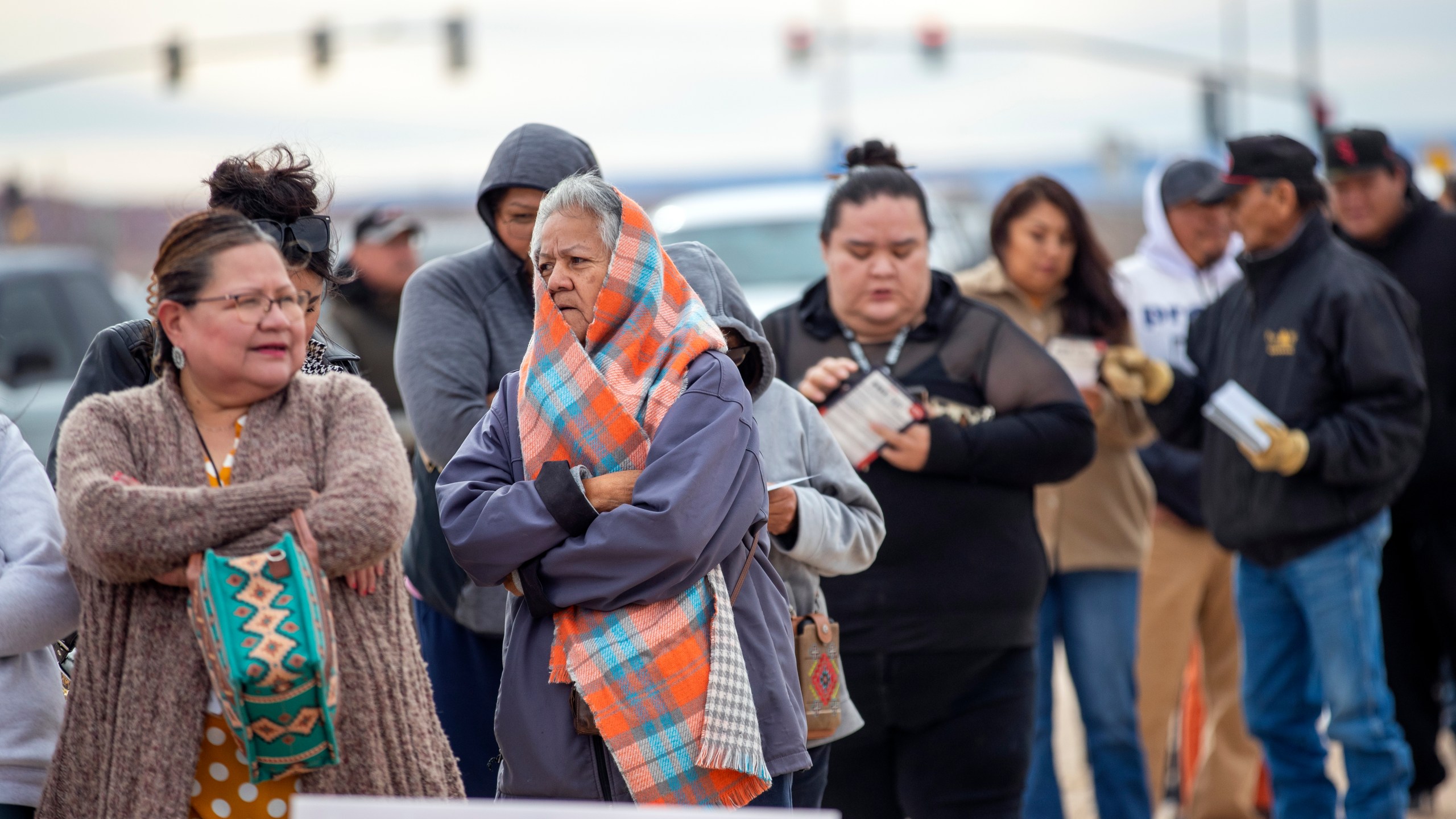 Voters wait in line to cast their ballots outside a polling station on the Navajo Nation in Chinle, Ariz., on Election Day, Tuesday, Nov. 5, 2024. (AP Photo/Andres Leighton)