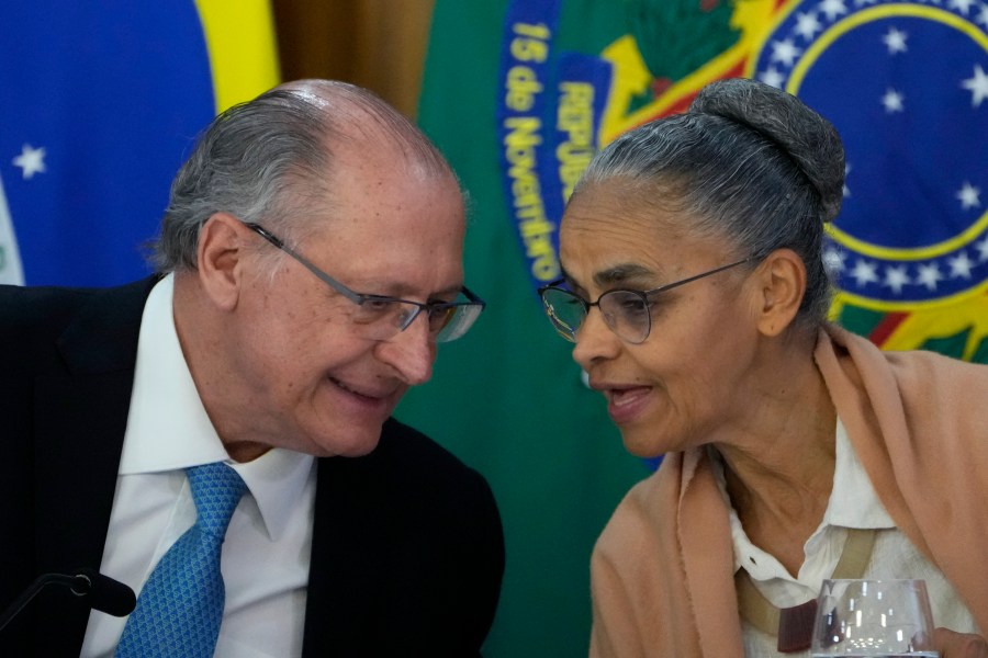 Brazil's Environment Minister Marina Silva, right, chats with Vice President Geraldo Alckmin during the announcement of a plan to combat fires and deforestation in the Amazon and the Brazilian Cerrado, at Planalto presidential palace in Brasilia, Brazil, Wednesday, Nov. 6, 2024. (AP Photo/Eraldo Peres)