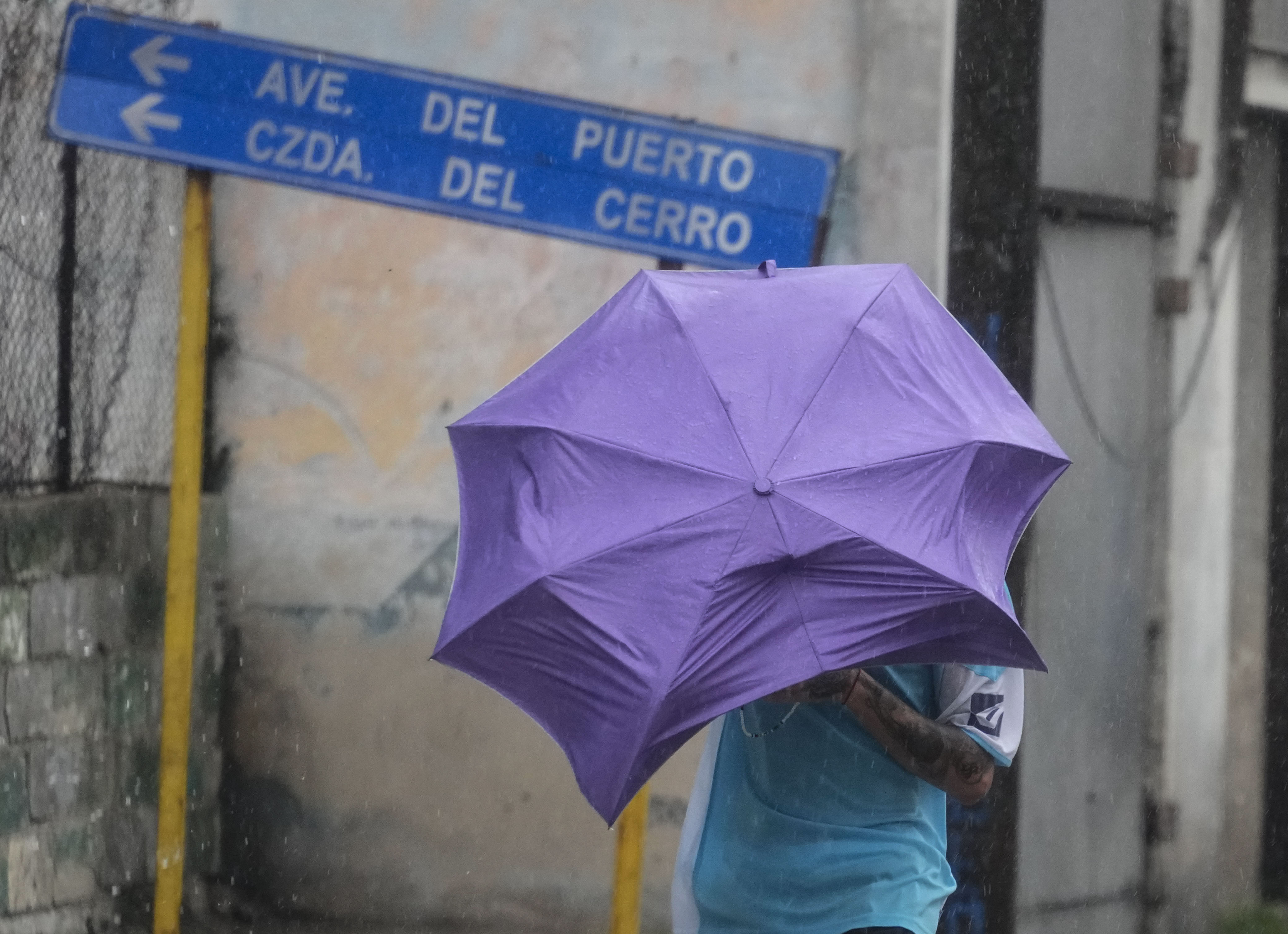 A man walks through the wind and rain brought by Hurricane Rafael in Havana, Cuba, Wednesday, Nov. 6, 2024. (AP Photo/Ramon Espinosa)