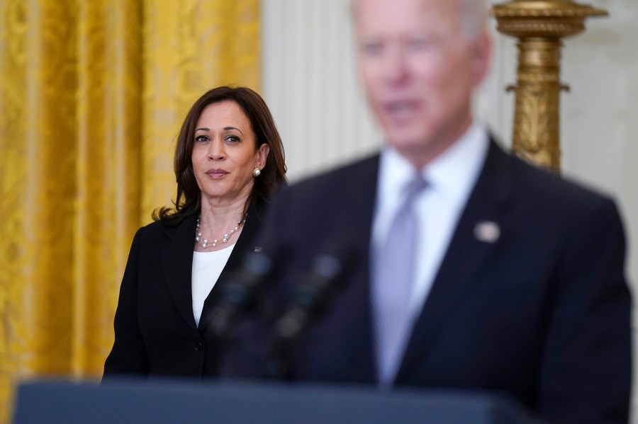 FILE - Vice President Kamala Harris listens as President Joe Biden speaks about distribution of COVID-19 vaccines, in the East Room of the White House, May 17, 2021, in Washington. (AP Photo/Evan Vucci, File)