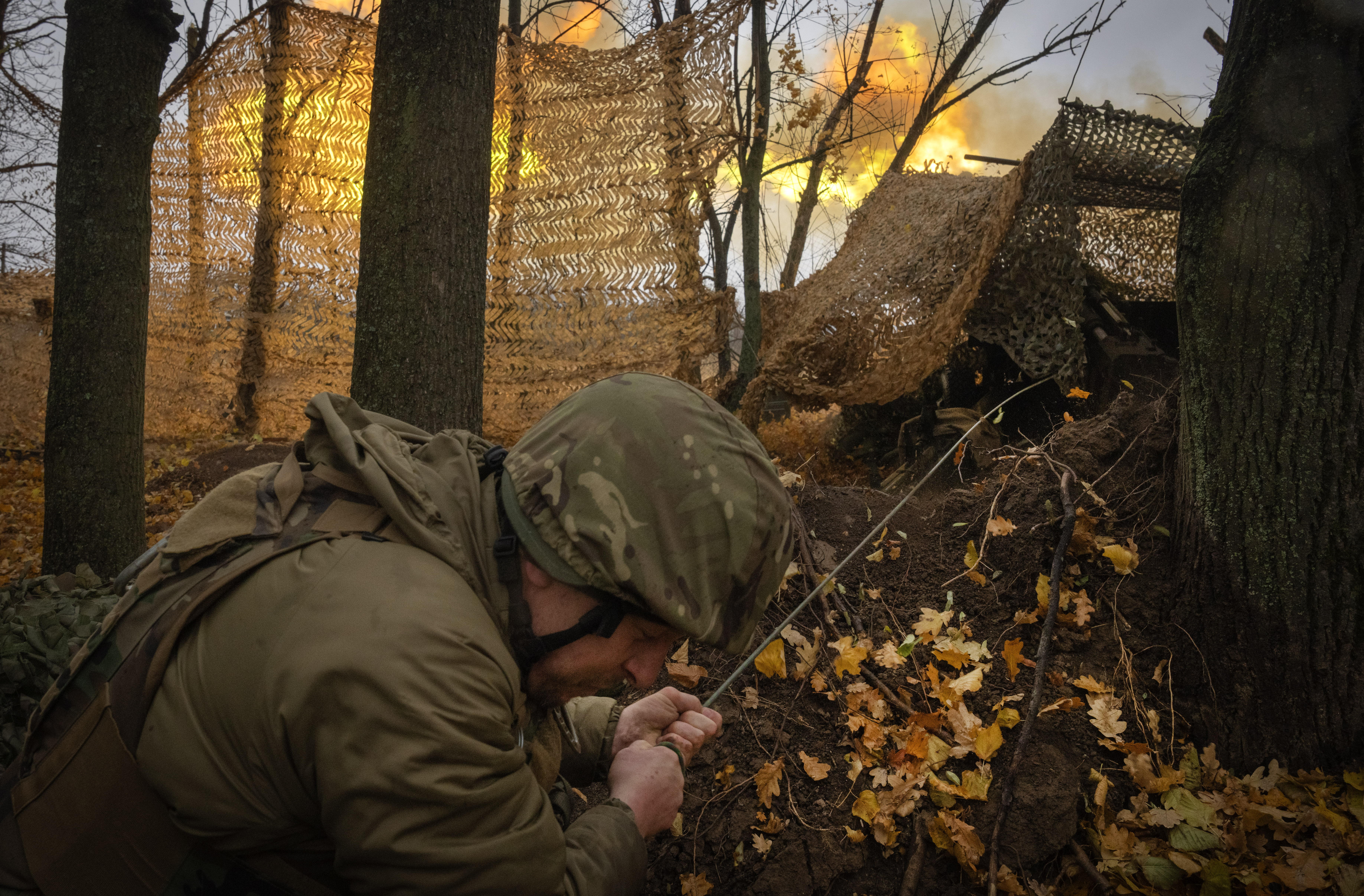 A serviceman of the 13th Brigade of the National Guard of Ukraine fires Giatsint-B gun towards Russian positions near Kharkiv, Ukraine, Wednesday, Nov. 6, 2024. (AP Photo/Efrem Lukatsky)