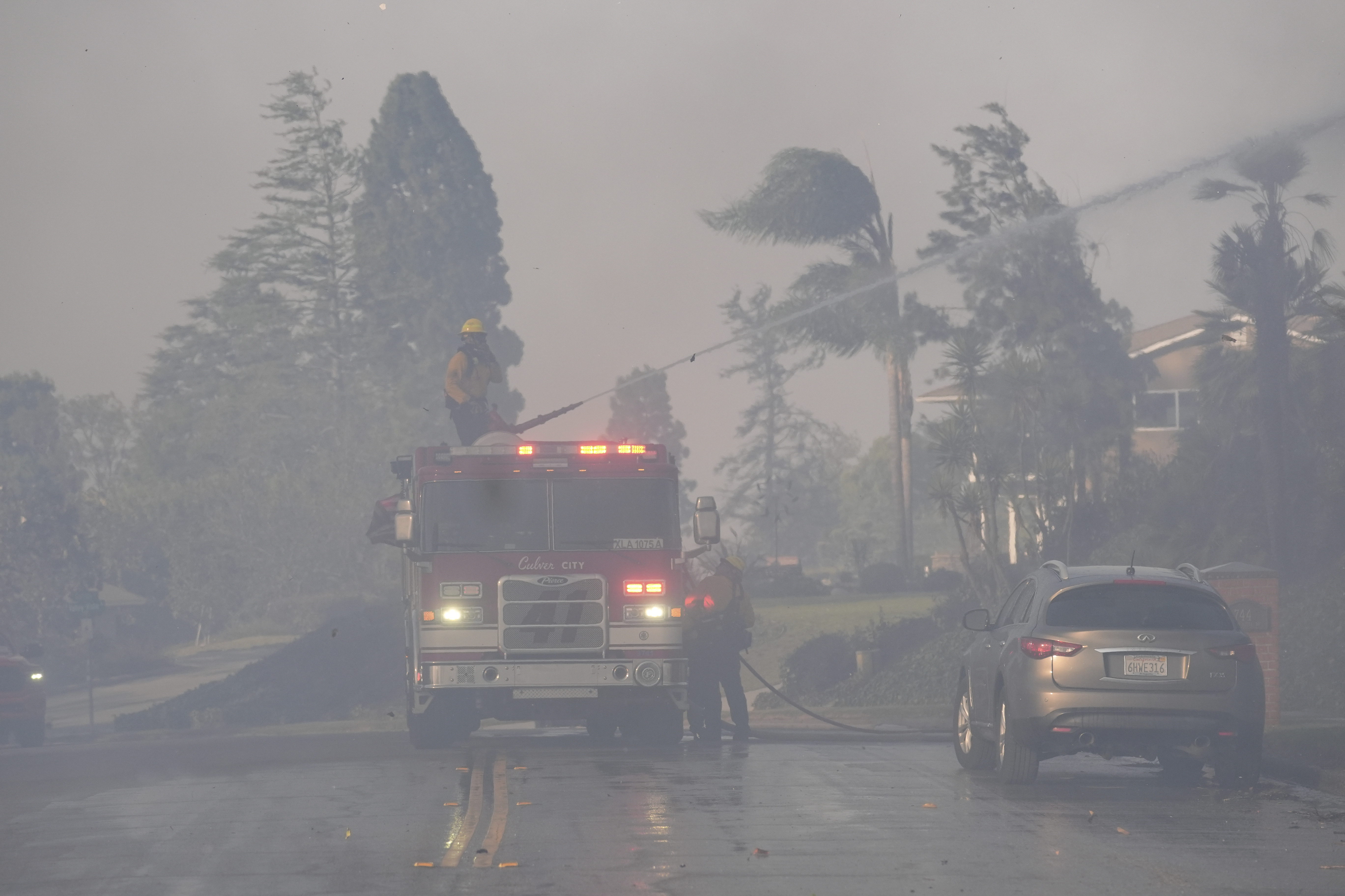 Firefighters work through heavy winds and smoke in the Mountain fire, Wednesday, Nov. 6, 2024, in Camarillo, Calif. (AP Photo/Marcio Jose Sanchez)