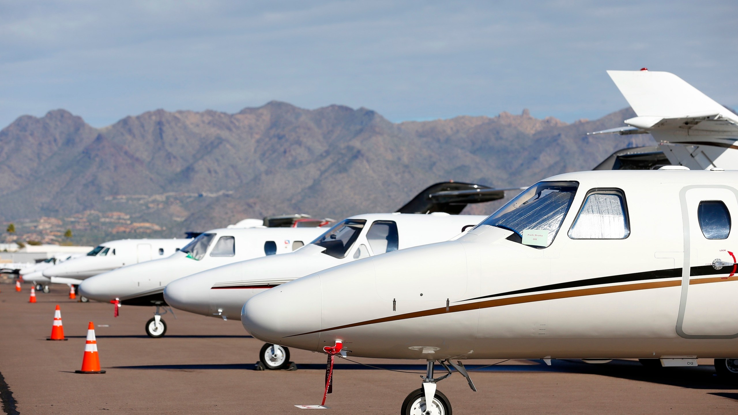 FILE - Private jets sit parked at Scottsdale Airport on Jan. 27, 2015, in Scottsdale, Ariz. (AP Photo/Ross D. Franklin, File)