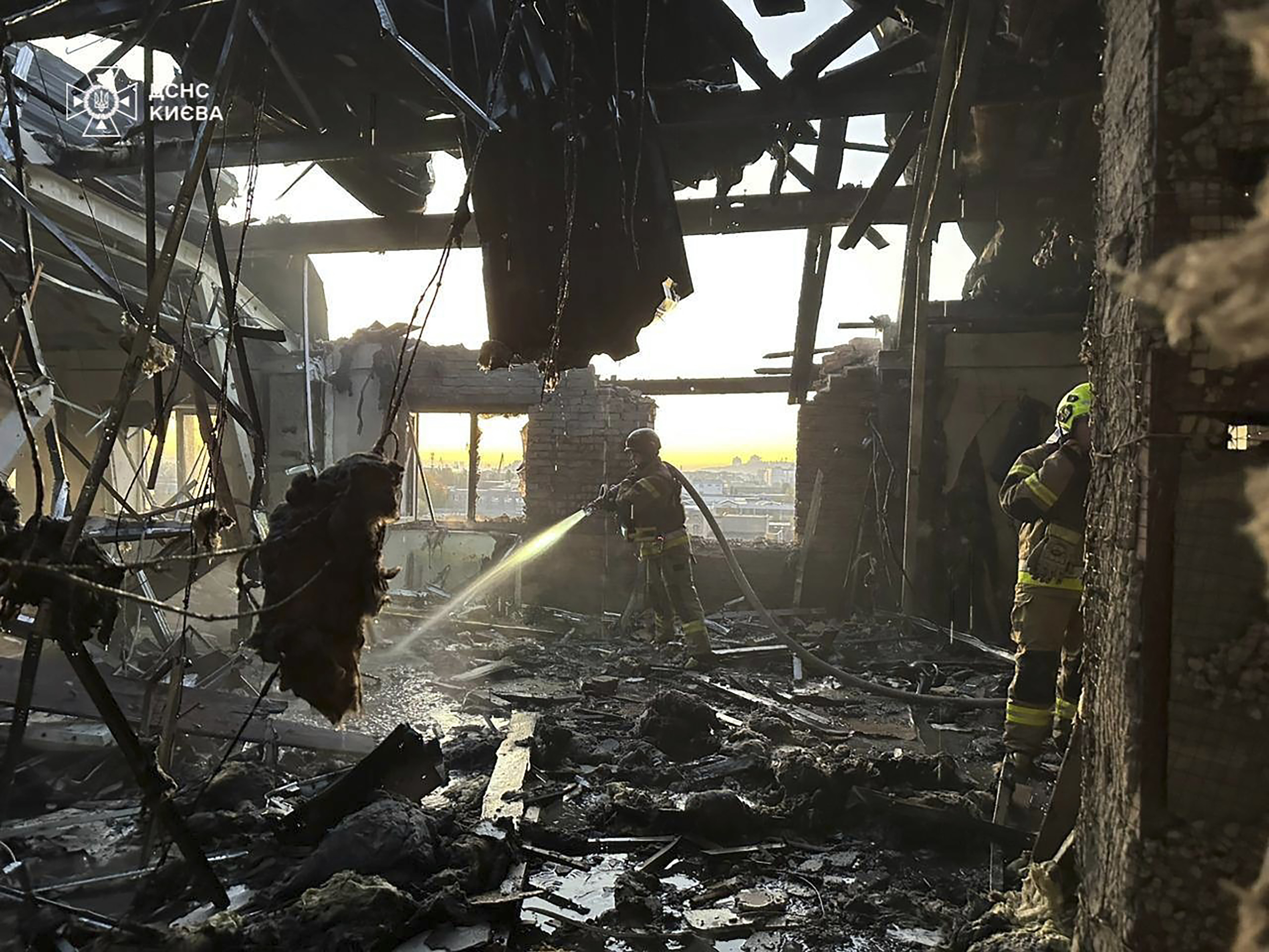 In this photo provided by the Ukrainian Emergency Service on Thursday, Nov. 7, 2024, a rescuer puts out a fire resulted from Russian drone attack in Kyiv, Ukraine. (Ukrainian Emergency Service via AP)