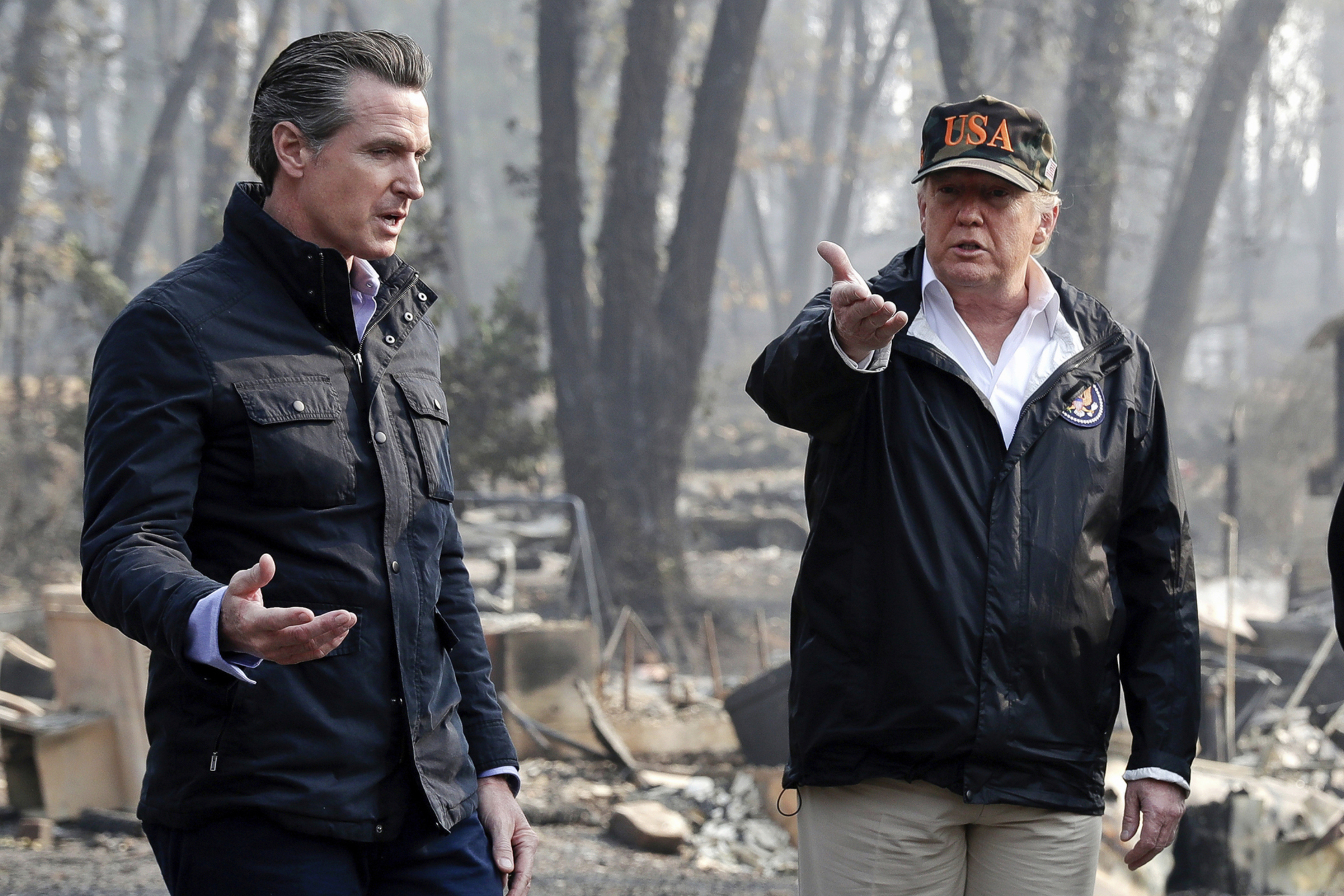 FILE - President Donald Trump talks with then California Gov.-elect Gavin Newsom, left, during a visit to a neighborhood impacted by the wildfires in Paradise, Calif., Nov. 17, 2018. (AP Photo/Evan Vucci, File)