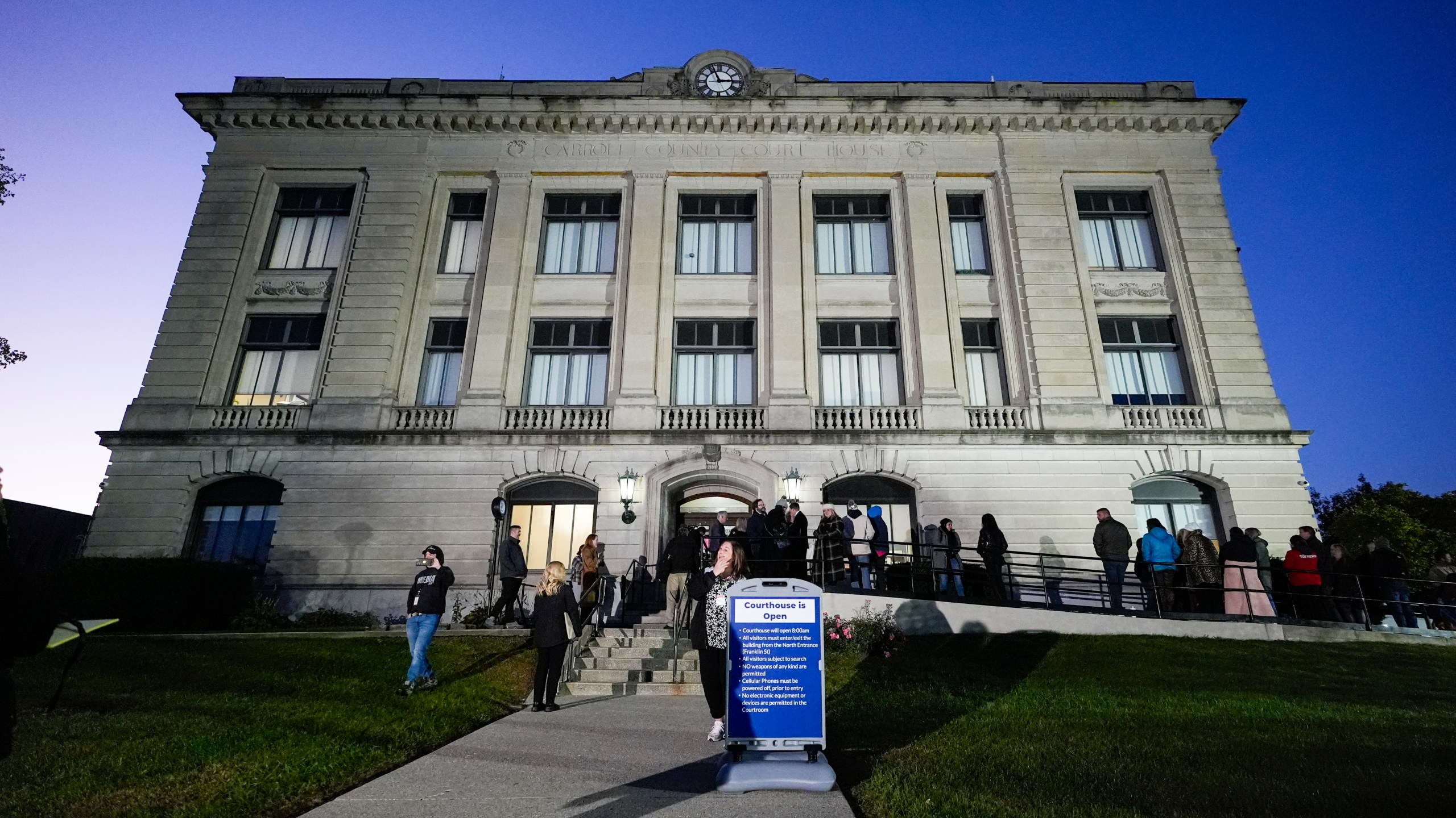 Spectators line up to enter the Carroll County Courthouse for the trail of Richard Allen, accused of the slayings of two teenage girls in 2017, is set to begin in Delphi, Ind., Friday, Oct. 18, 2024. (AP Photo/Michael Conroy)