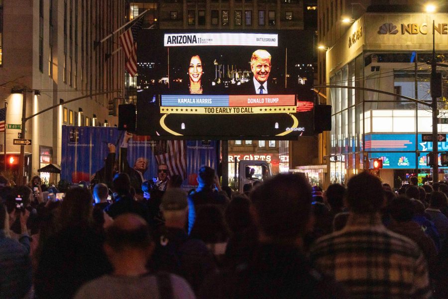 People watch an NBC News livestream showing poll results at Rockefeller Center in New York on Election Day, Tuesday, Nov. 5, 2024. (AP Photo/Yuki Iwamura)