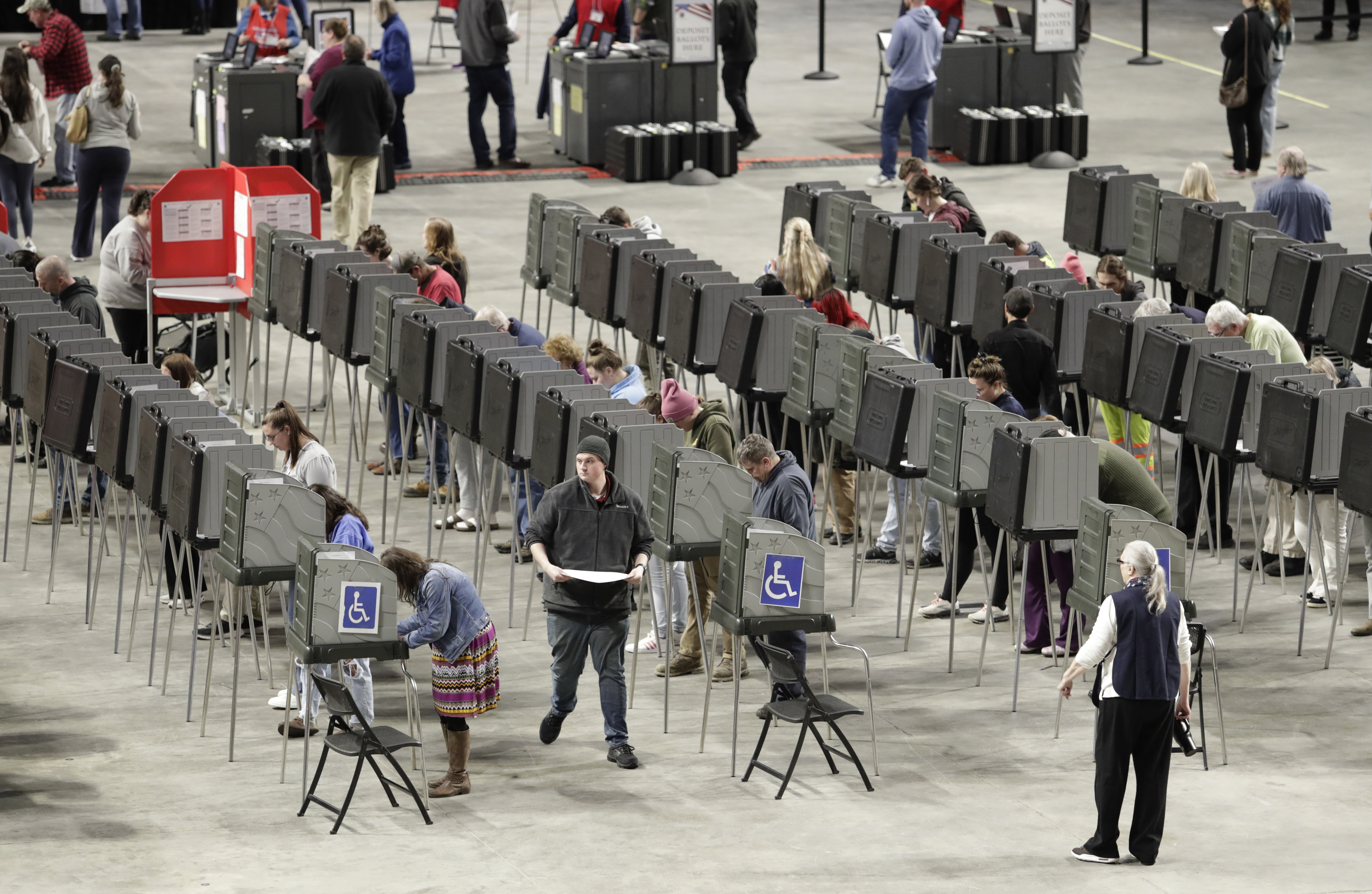 Voters fill out their ballots on Election Day Tuesday, Nov. 5, 2024, at the Cross Insurance Center in Bangor, Maine. (AP Photo/Joel Page)