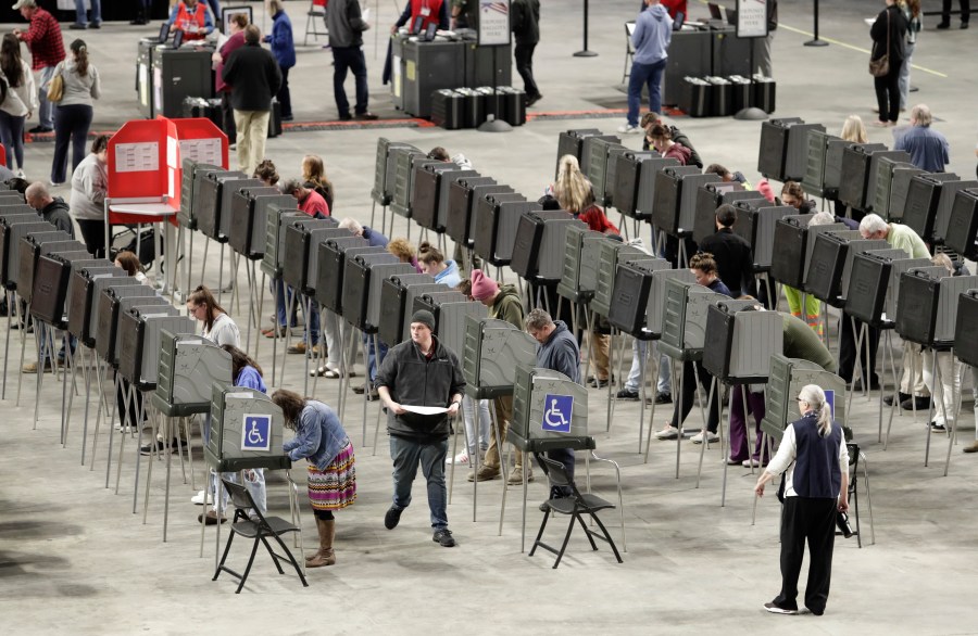 Voters fill out their ballots on Election Day Tuesday, Nov. 5, 2024, at the Cross Insurance Center in Bangor, Maine. (AP Photo/Joel Page)