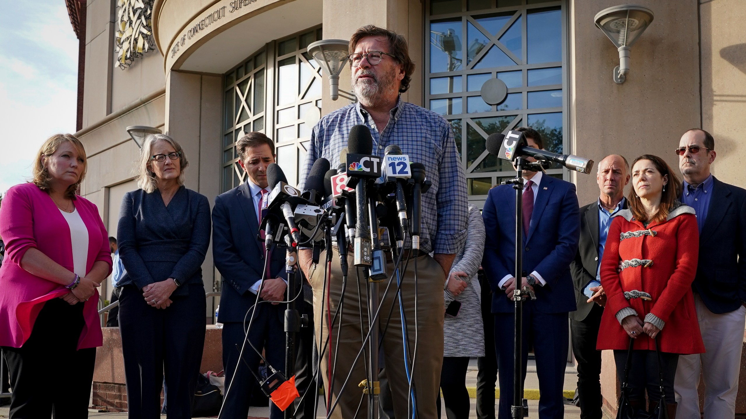 FILE - Bill Sherlach, husband of Mary, one of the Sandy Hook School shooting victims, speaks to the media after jurors returned a $965 million dollar judgement in the defamation trial against Alex Jones, in Waterbury, Conn., Oct. 12, 2022. (AP Photo/Bryan Woolston, File)