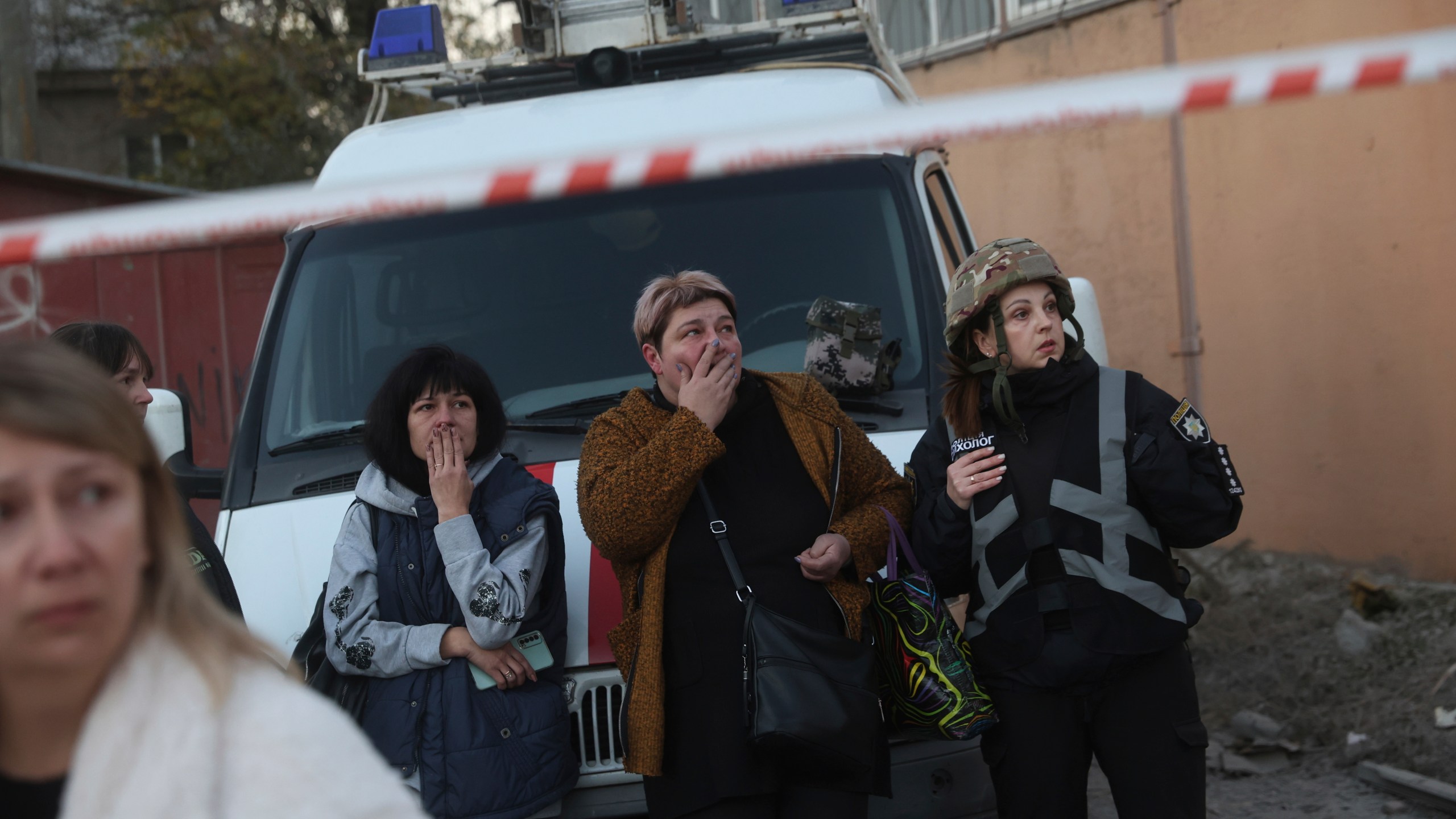 Local women react on destruction of a residential building destroyed by a Russian airstrike in Zaporizhzhia, Ukraine, Thursday, Nov. 7, 2024. (AP Photo/Kateryna Klochko)