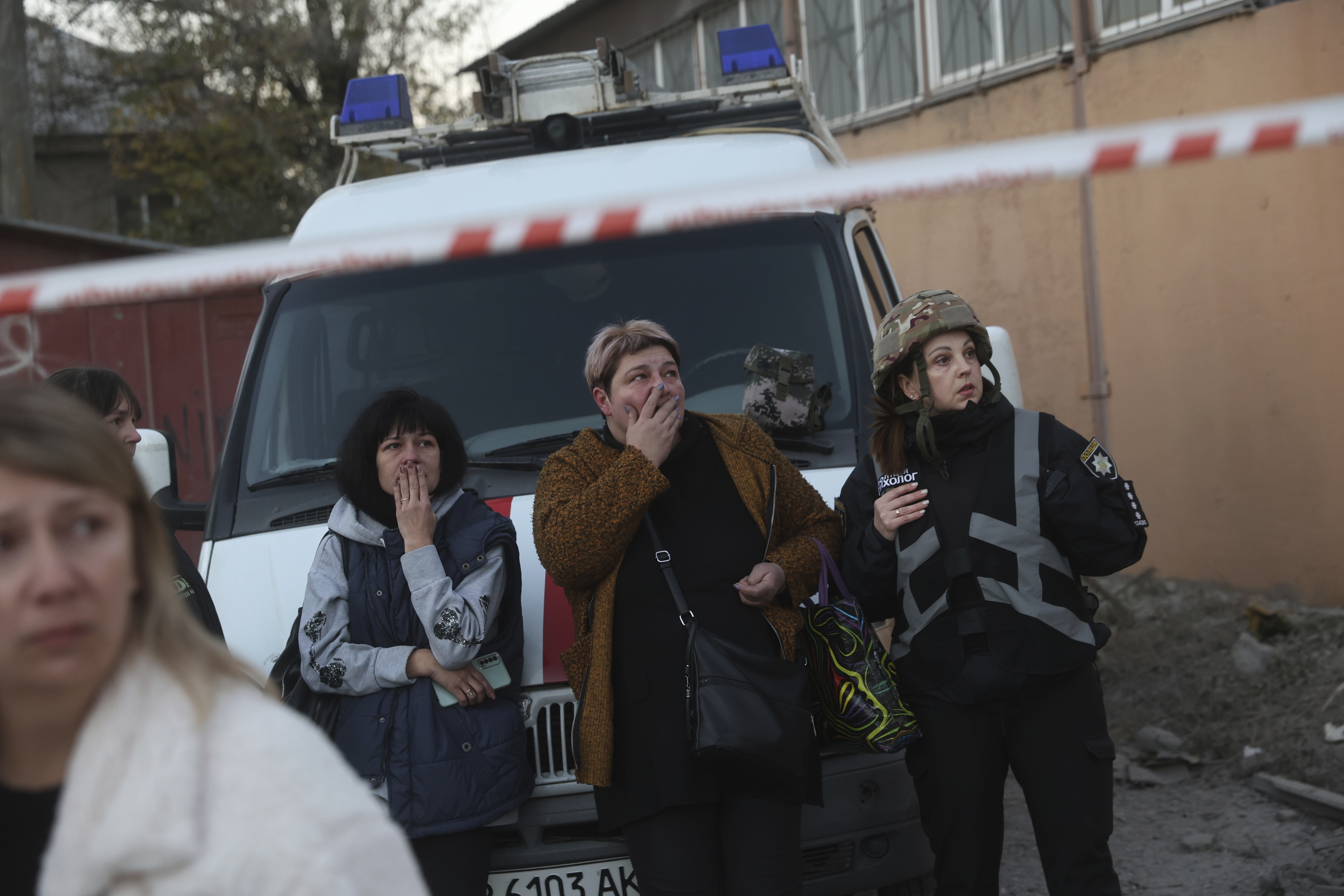 Local women react on destruction of a residential building destroyed by a Russian airstrike in Zaporizhzhia, Ukraine, Thursday, Nov. 7, 2024. (AP Photo/Kateryna Klochko)