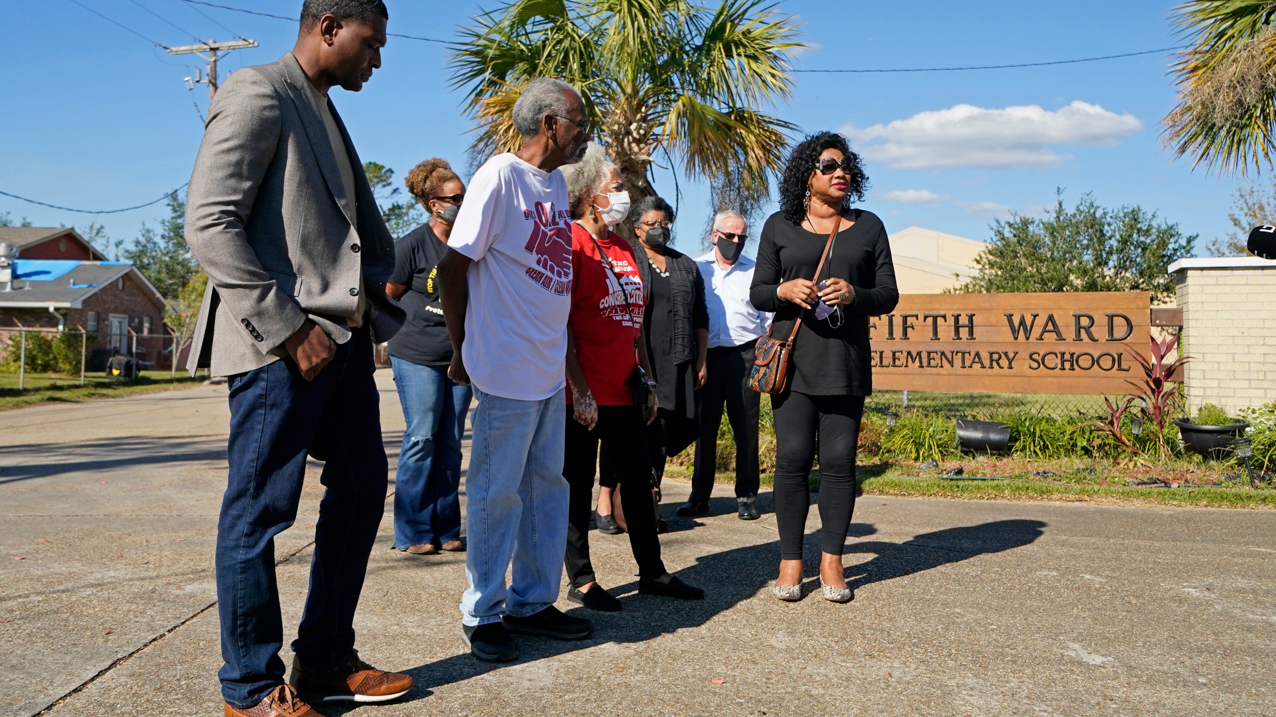 FILE - EPA Administrator Michael Regan, left, arrives at the Fifth Ward Elementary School, which is near the Denka plant, with Robert Taylor, second left, founder of Concerned Citizens of St. John's Parish, and Lydia Gerard, third left, a member of the group, in Reserve, La., Nov. 16, 2021. (AP Photo/Gerald Herbert, File)