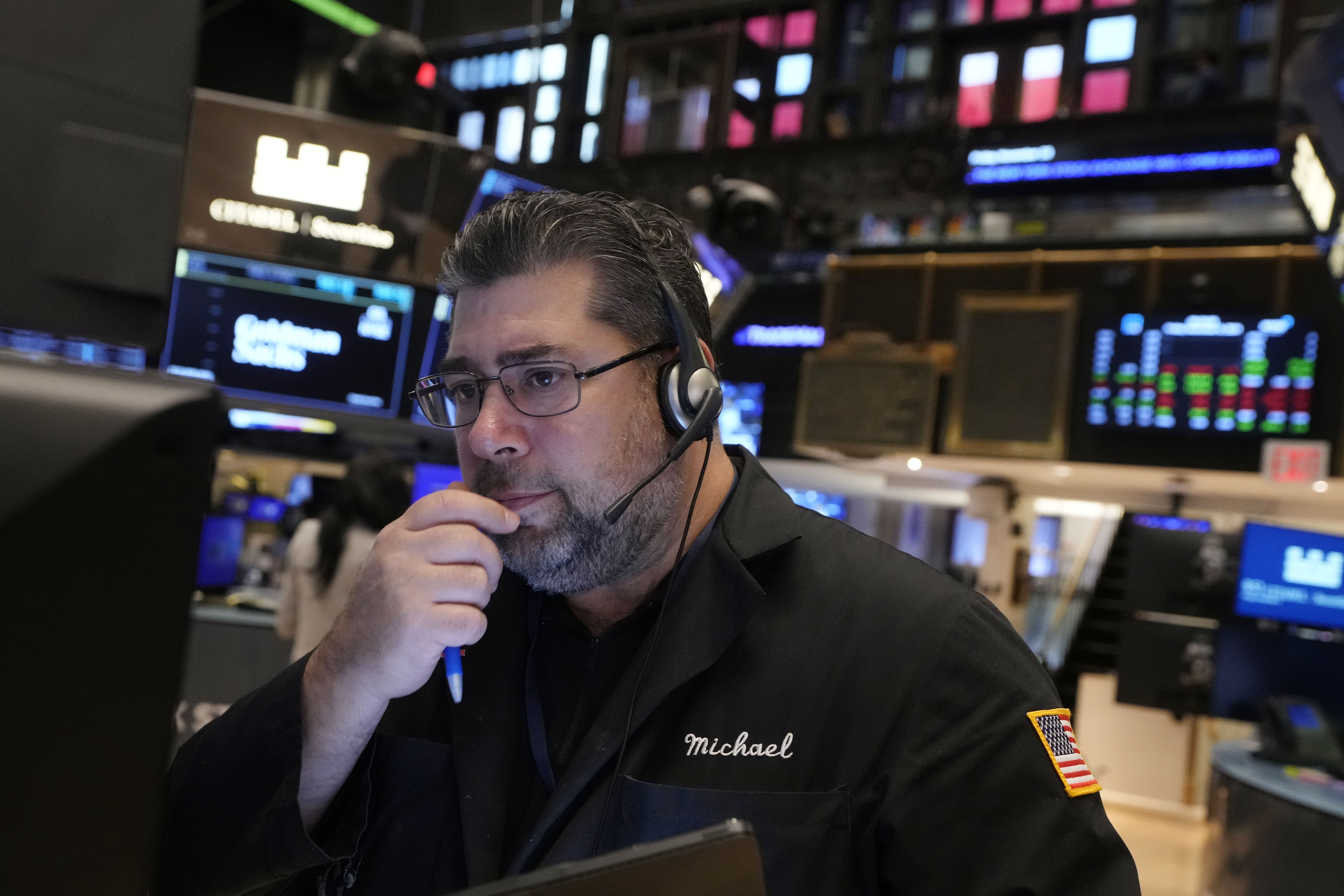 Trader Michael Capolinoi works on the floor of the New York Stock Exchange, Friday, Nov. 8, 2024. (AP Photo/Richard Drew)