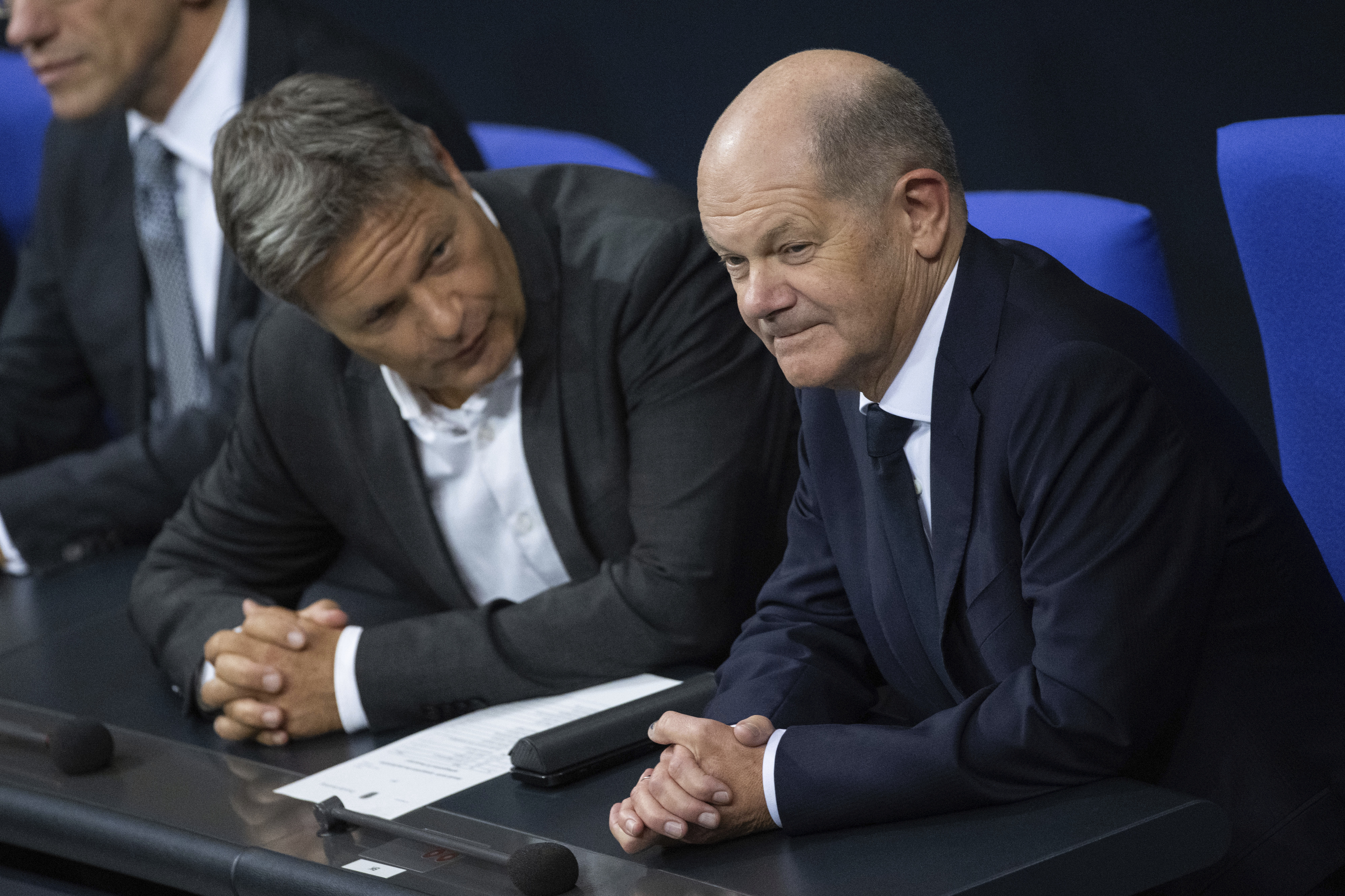 German Economy and Climate Minister Robert Habeck, left, talks to German Chancellor Olaf Scholz, right, during a meeting of the German federal parliament, Bundestag, at the Reichstag building in Berlin, Germany, Thursday, Nov. 7, 20024. (Christophe Gateau/dpa via AP)