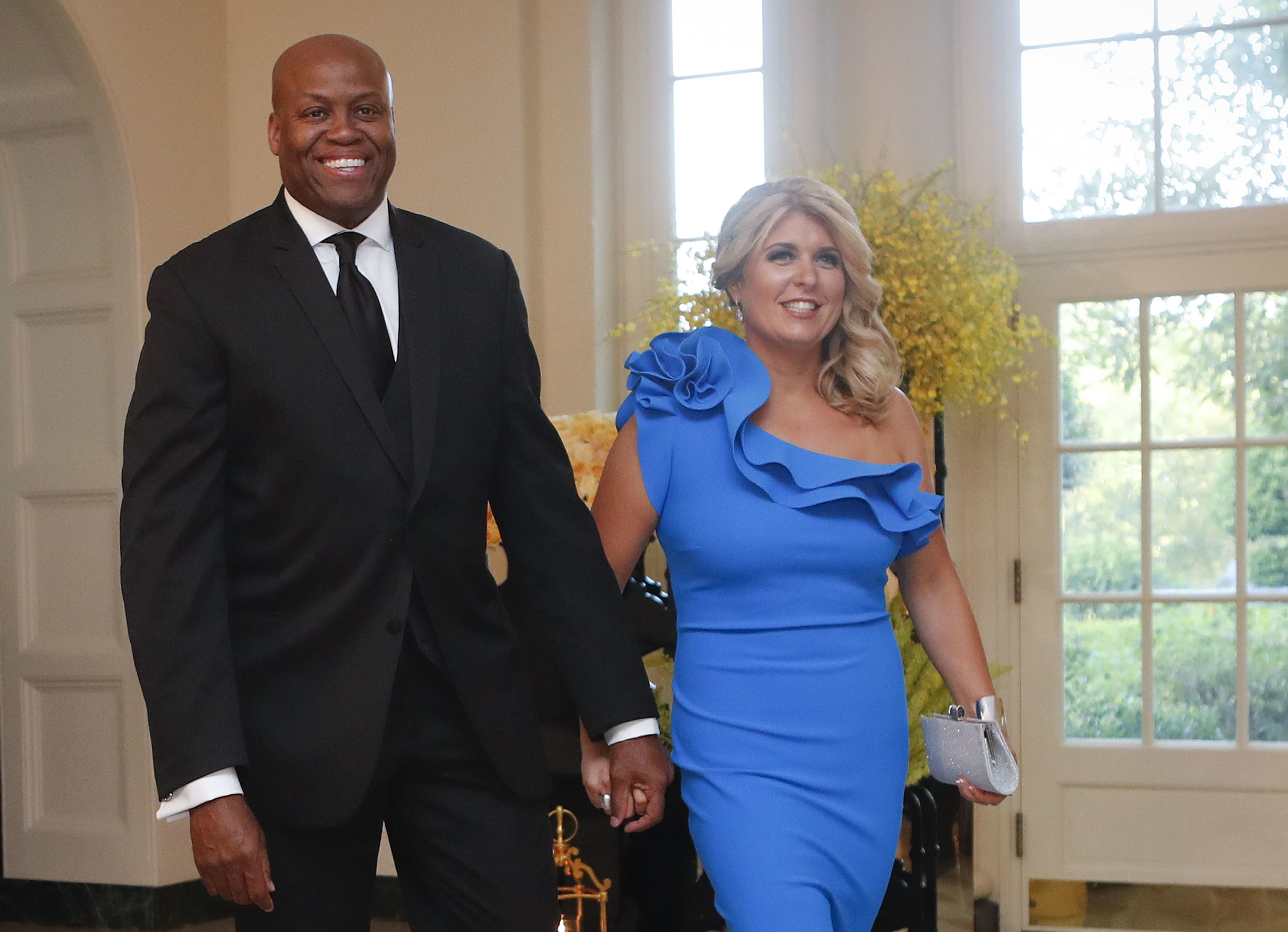 FILE - Craig Robinson, brother of former first lady Michelle Obama, and his wife, Kelly Robinson, arrive for a State Dinner for Singapore's Prime Minister Lee Hsien Loong, Aug. 2, 2016, at the White House in Washington. (AP Photo/Pablo Martinez Monsivais, File)