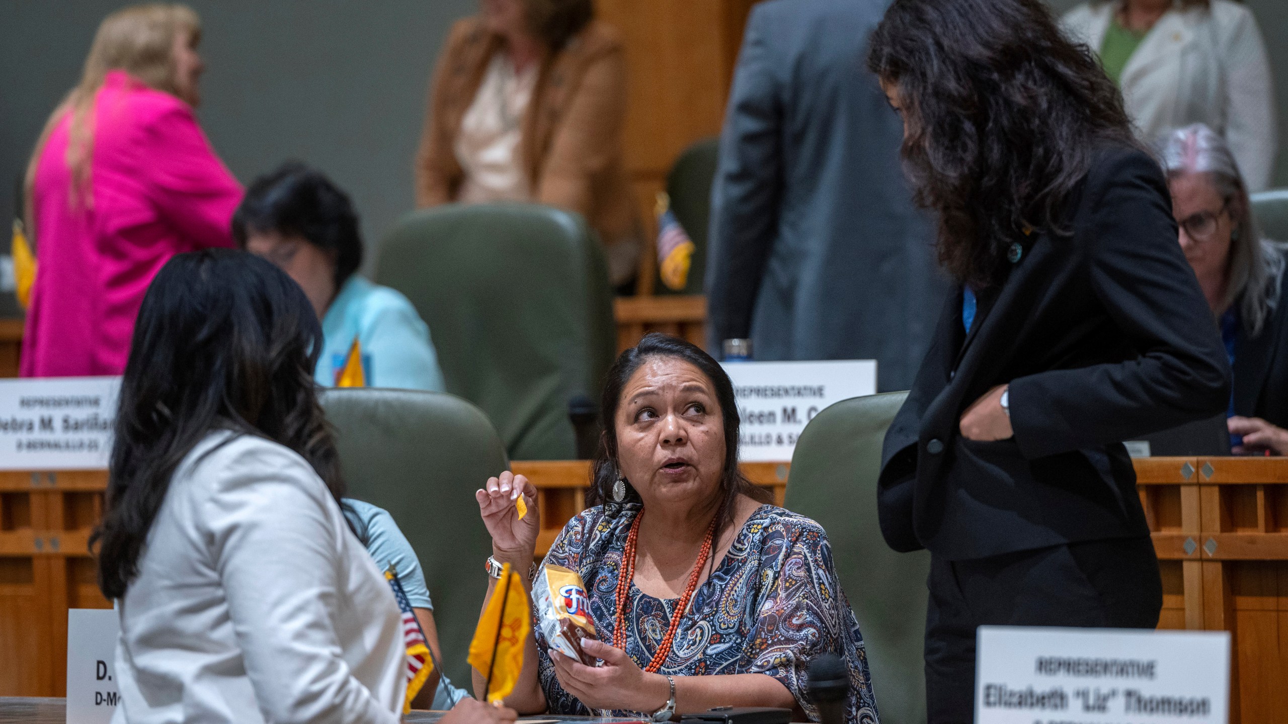 House Maj. Whip Reena Szczepanski, D-Santa Fe, left, Rep. D. Wonda Johnson, D-Church Rock, center, and Rep. Cristina Parajon, D-Albuquerque, talk before the start of a special session, in Santa Fe, N.M., Thursday, July 18, 2024. (Eddie Moore/The Albuquerque Journal via AP)