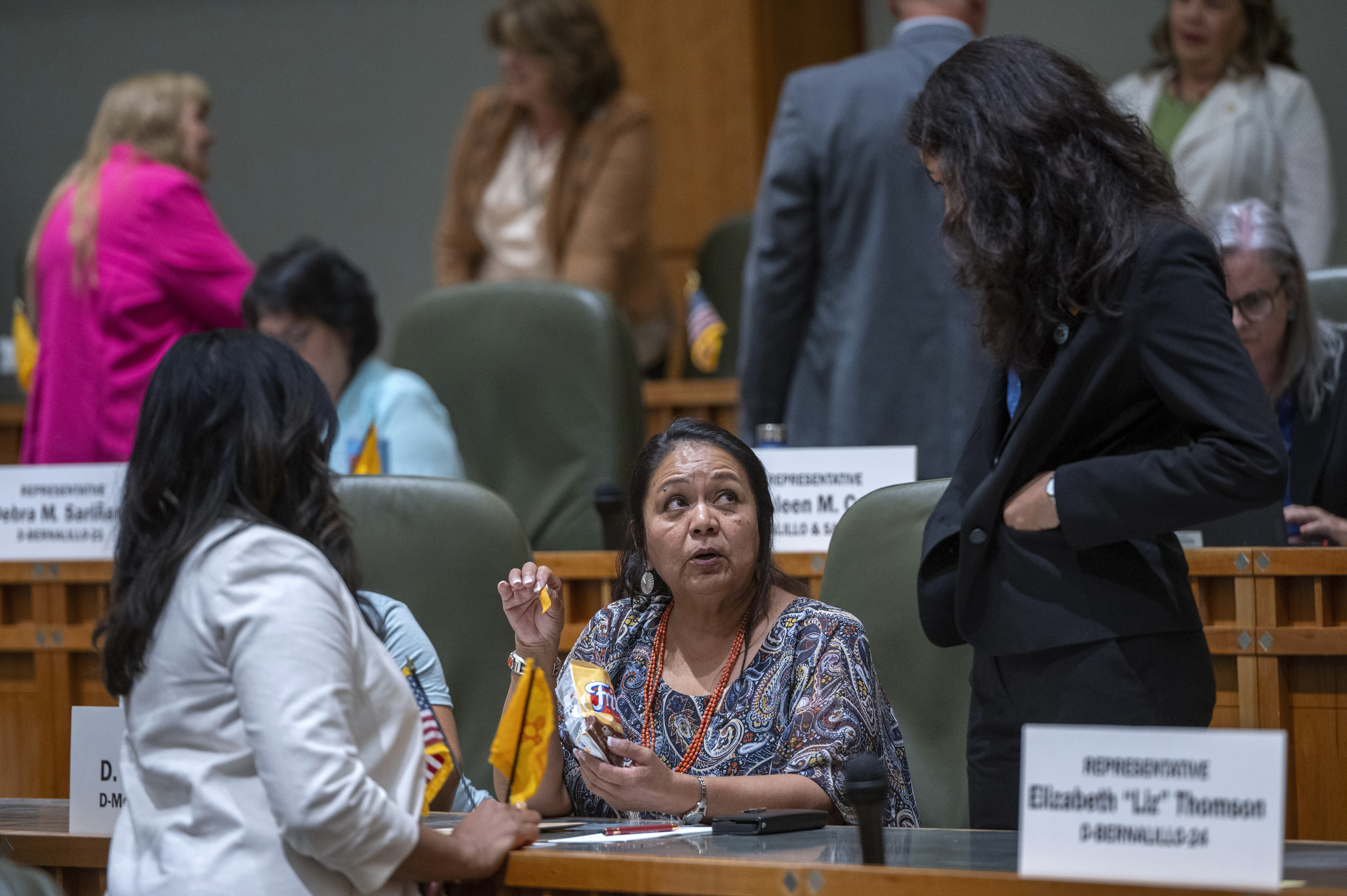 House Maj. Whip Reena Szczepanski, D-Santa Fe, left, Rep. D. Wonda Johnson, D-Church Rock, center, and Rep. Cristina Parajon, D-Albuquerque, talk before the start of a special session, in Santa Fe, N.M., Thursday, July 18, 2024. (Eddie Moore/The Albuquerque Journal via AP)