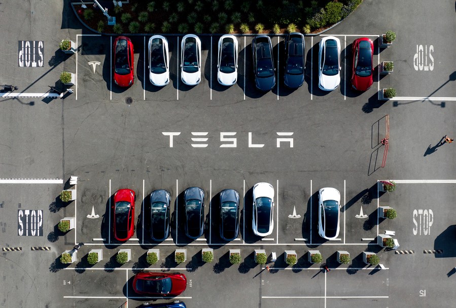 FILE - Tesla vehicles line a parking lot at the company's Fremont, Calif., factory, on Sept. 18, 2023. (AP Photo/Noah Berger, File)