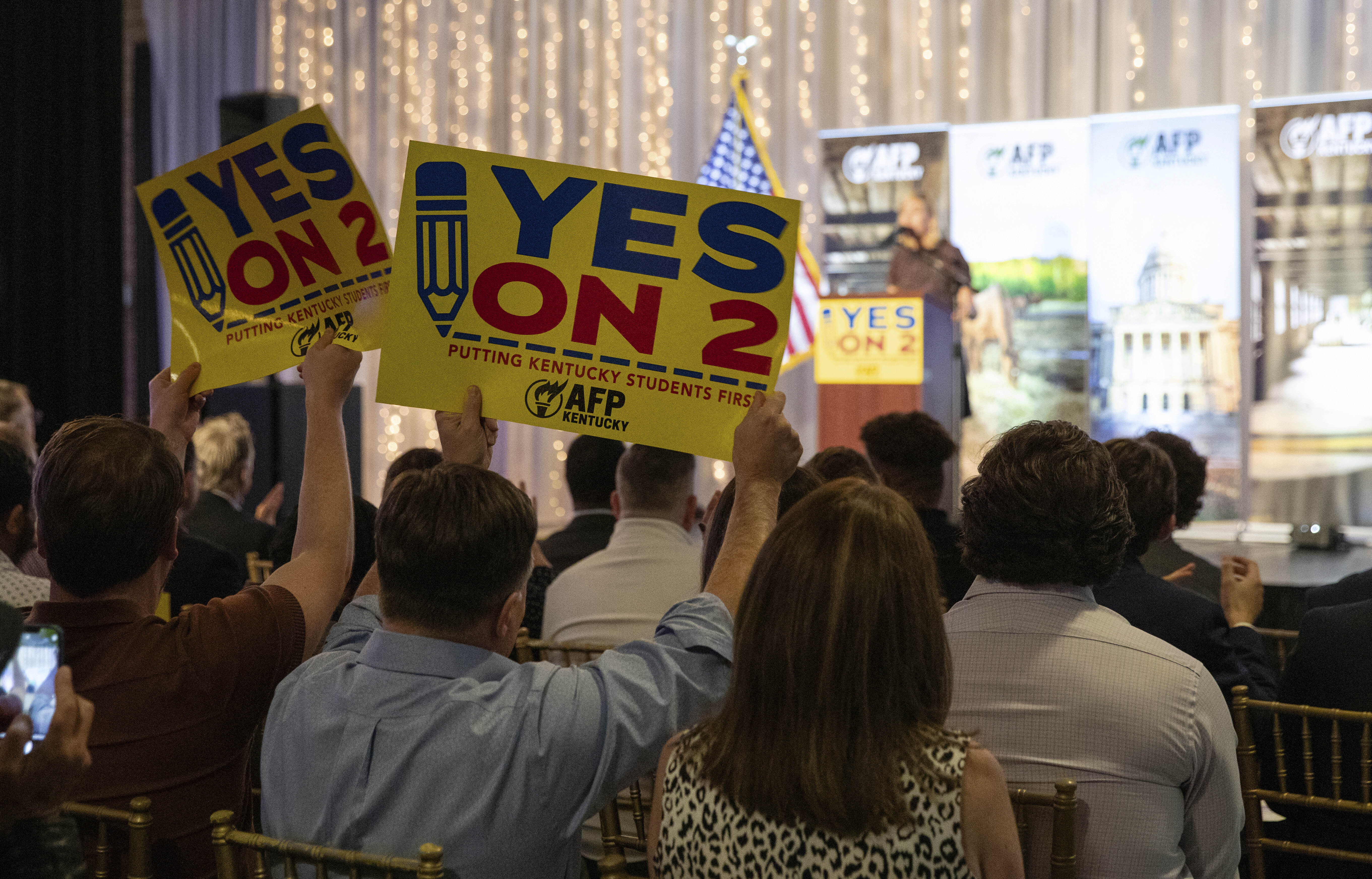 Supporters of Kentucky's Amendment 2 wave signs and foam fingers as Kelley Paul speaks at the Americans for Prosperity—Kentucky rally for Amendment 2 alongside her husband, U.S. Sen. Rand Paul, and former Kentucky Attorney Gen. Daniel Cameron at La Gala in downtown Bowling Green, Ky., Monday, Oct. 28, 2024. (Grace Ramey McDowell/Daily News via AP)