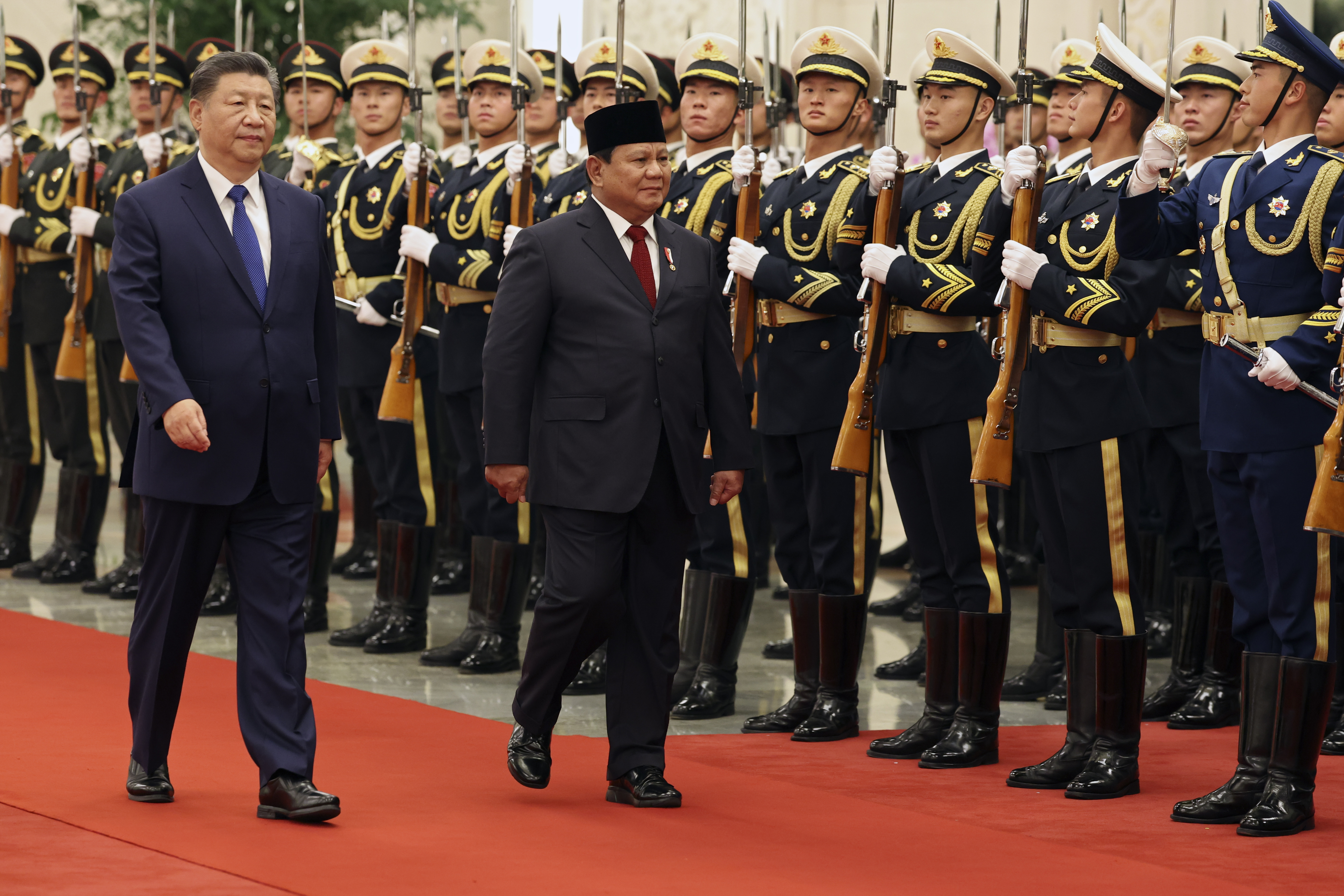 Chinese President Xi Jinping, left, and Indonesia's President Prabowo Subianto review the honour guard during a welcome ceremony at the Great Hall of the People in Beijing, China, Nov. 9, 2024. (Florence Lo/Pool Photo via AP)