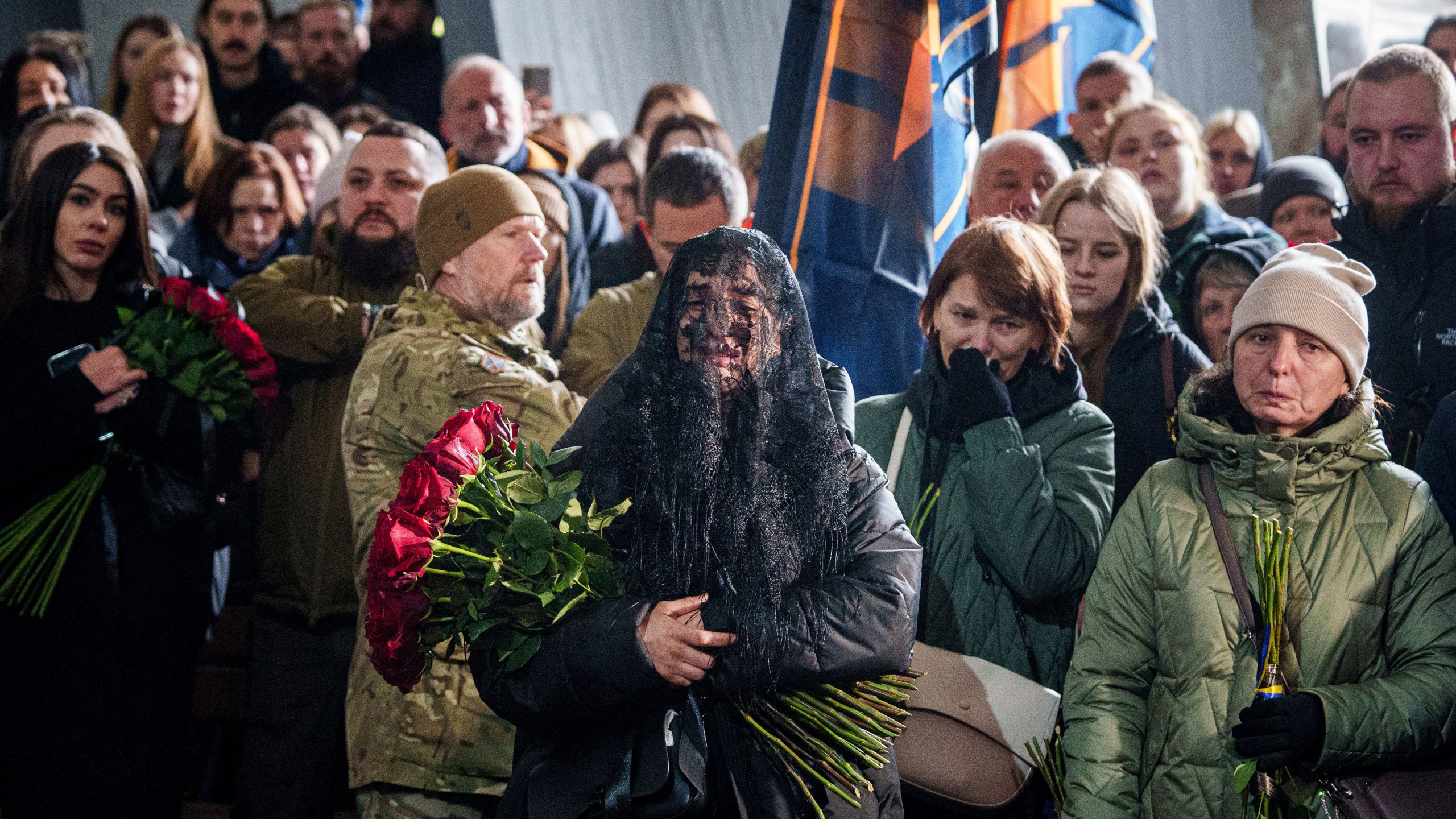 A woman cries near the coffin of Valentyna Nagorna aka "Valkiria", Ukrainian military medic of 3rd assault brigade, who was killed together with his boyfriend Danylo Liashkevych aka "Berserk, during the funeral ceremony at crematorium in Kyiv, Ukraine, Friday, Nov. 8, 2024. (AP Photo/Evgeniy Maloletka)