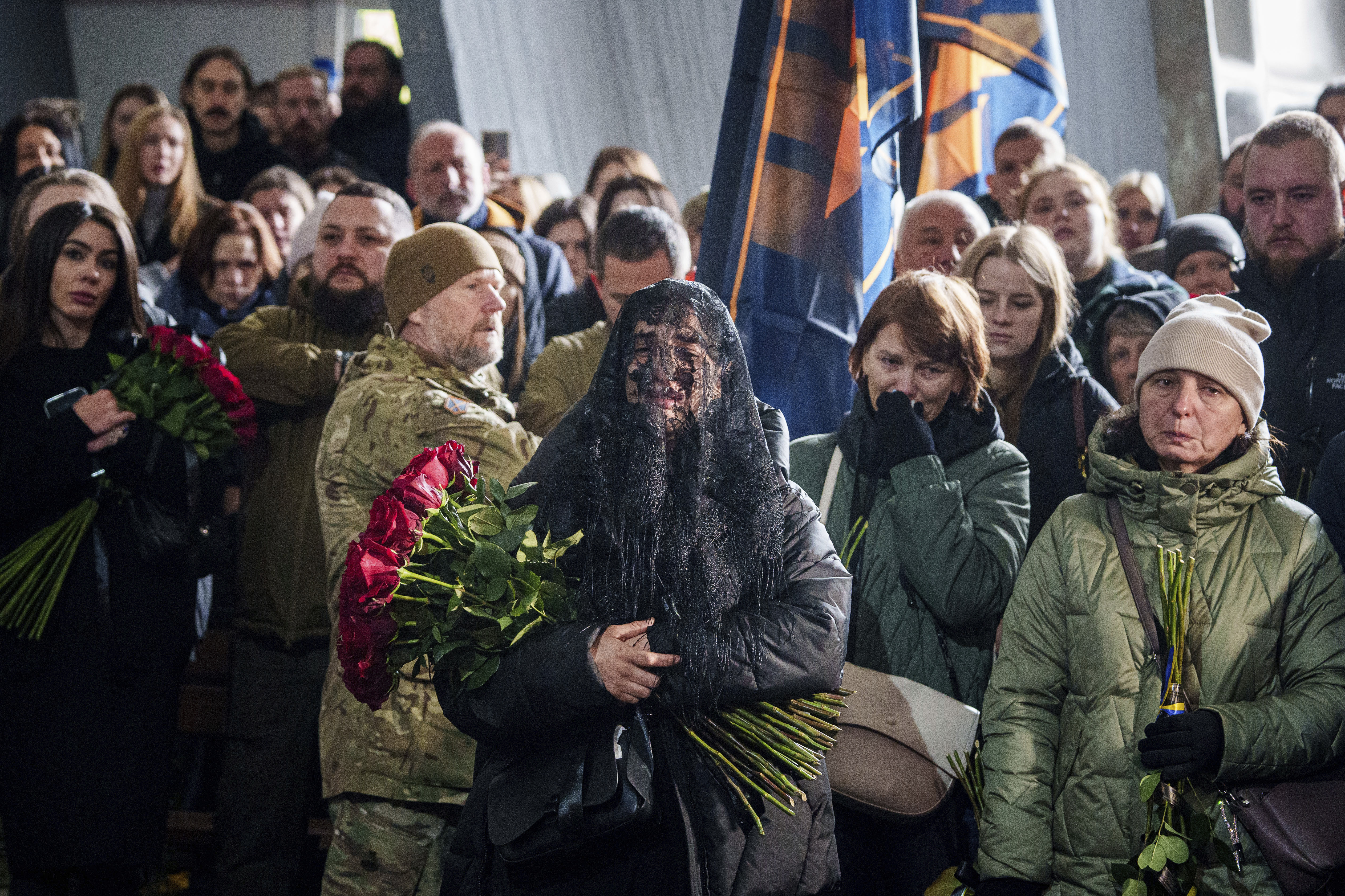 A woman cries near the coffin of Valentyna Nagorna aka "Valkiria", Ukrainian military medic of 3rd assault brigade, who was killed together with his boyfriend Danylo Liashkevych aka "Berserk, during the funeral ceremony at crematorium in Kyiv, Ukraine, Friday, Nov. 8, 2024. (AP Photo/Evgeniy Maloletka)