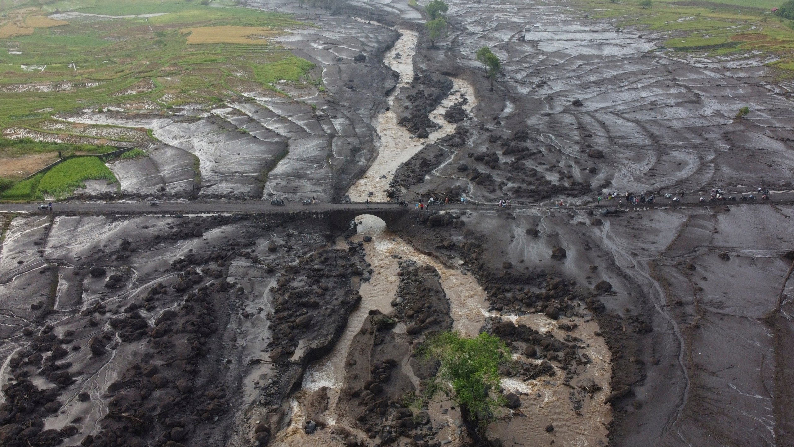 FILE - People examine the damage at an area badly affected by a flash flood in Tanah Datar, West Sumatra, Indonesia, May 13, 2024. (AP Photo/Ali Nayaka, File)