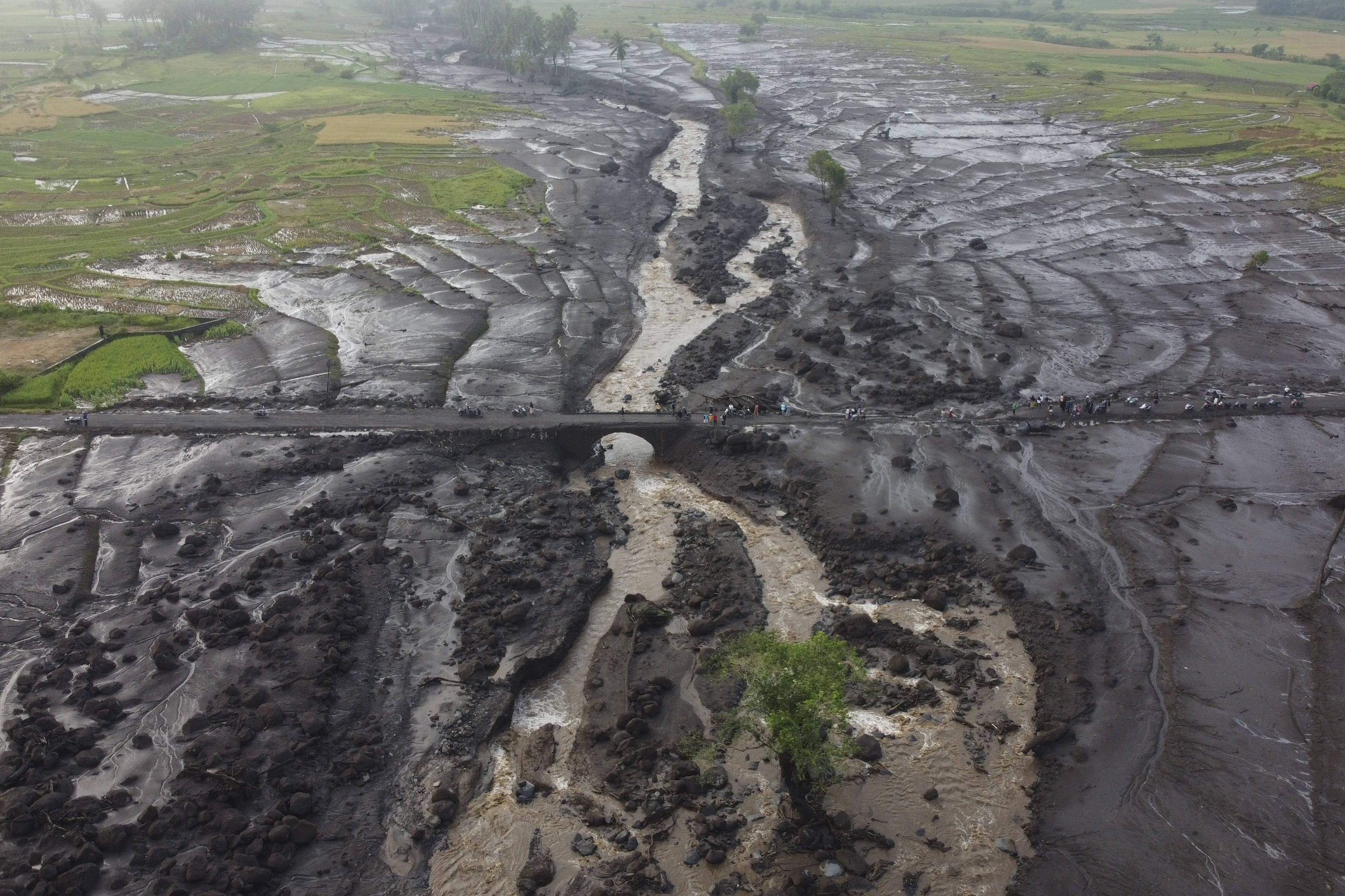 FILE - People examine the damage at an area badly affected by a flash flood in Tanah Datar, West Sumatra, Indonesia, May 13, 2024. (AP Photo/Ali Nayaka, File)