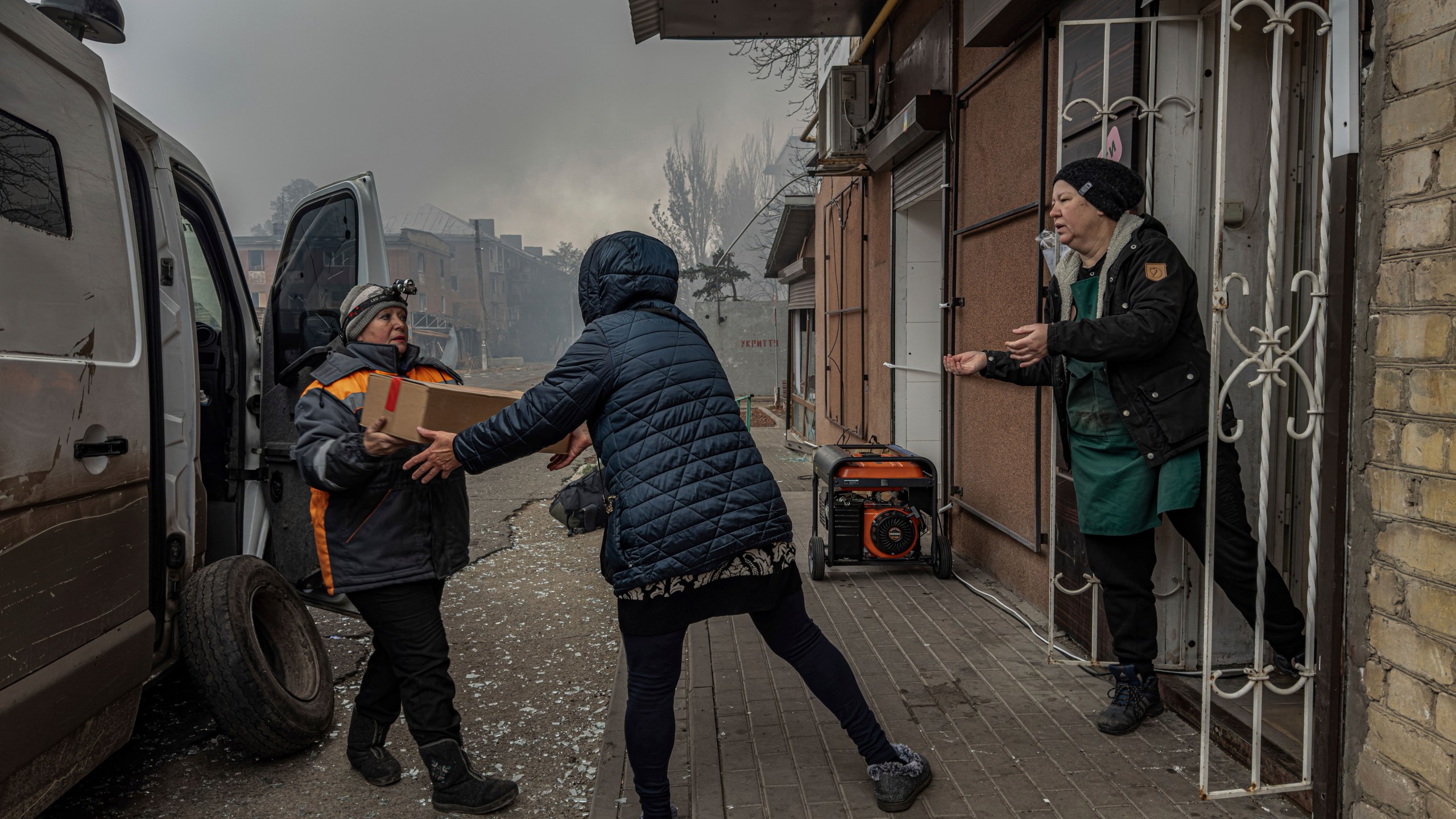 Local women unload food products from a minivan into the last shop operating in Kurakhove, Donetsk region, Ukraine, on Nov. 7, 2024. (AP Photo/Anton Shtuka)