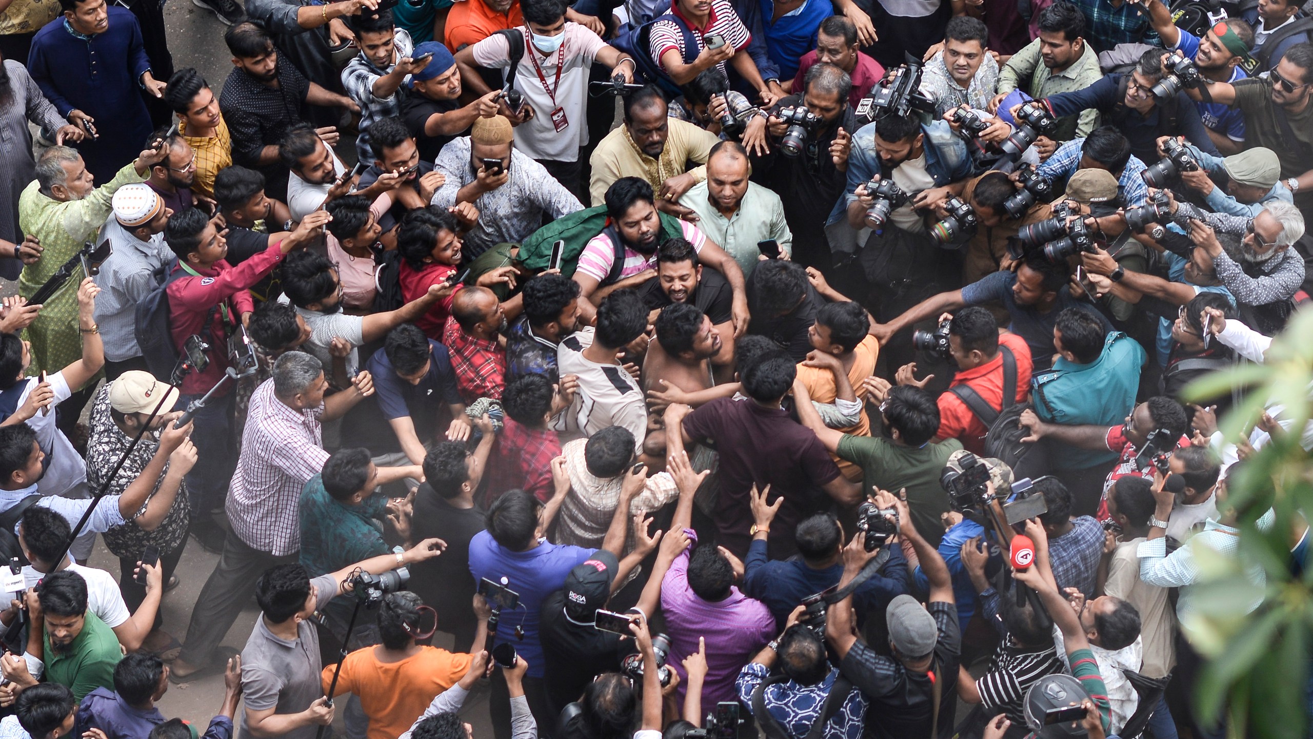 Students from anti-discrimination movements and Bangladesh Nationalist Party activists attack an Awami League supporter in Dhaka, Bangladesh, Sunday, Nov. 10, 2024. (AP Photo/Mahmud Hossain Opu)