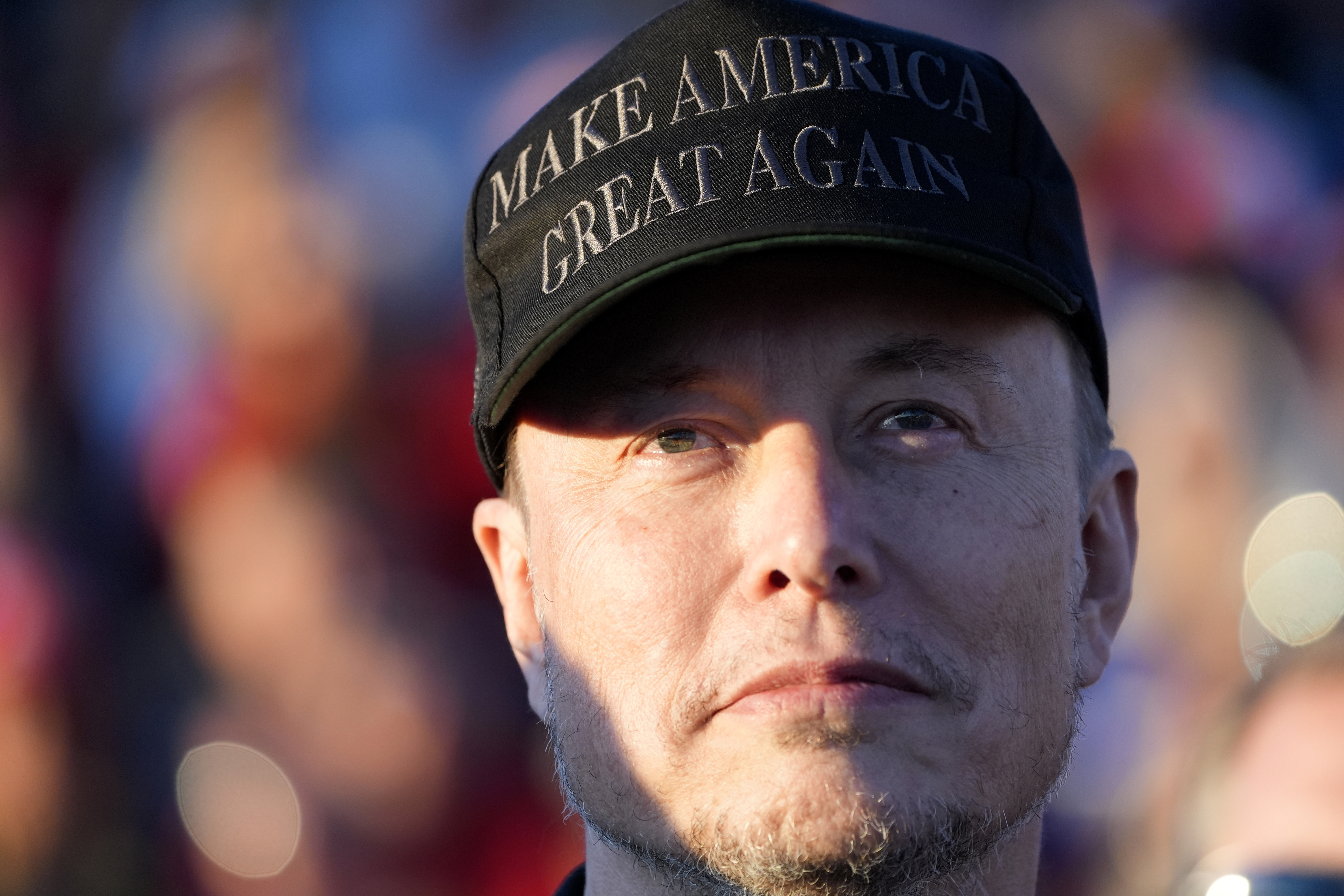 FILE - Tesla and SpaceX CEO Elon Musk listens as Republican presidential nominee former President Donald Trump speaks at a campaign event at the Butler Farm Show, Oct. 5, 2024, in Butler, Pa. (AP Photo/Alex Brandon, File)