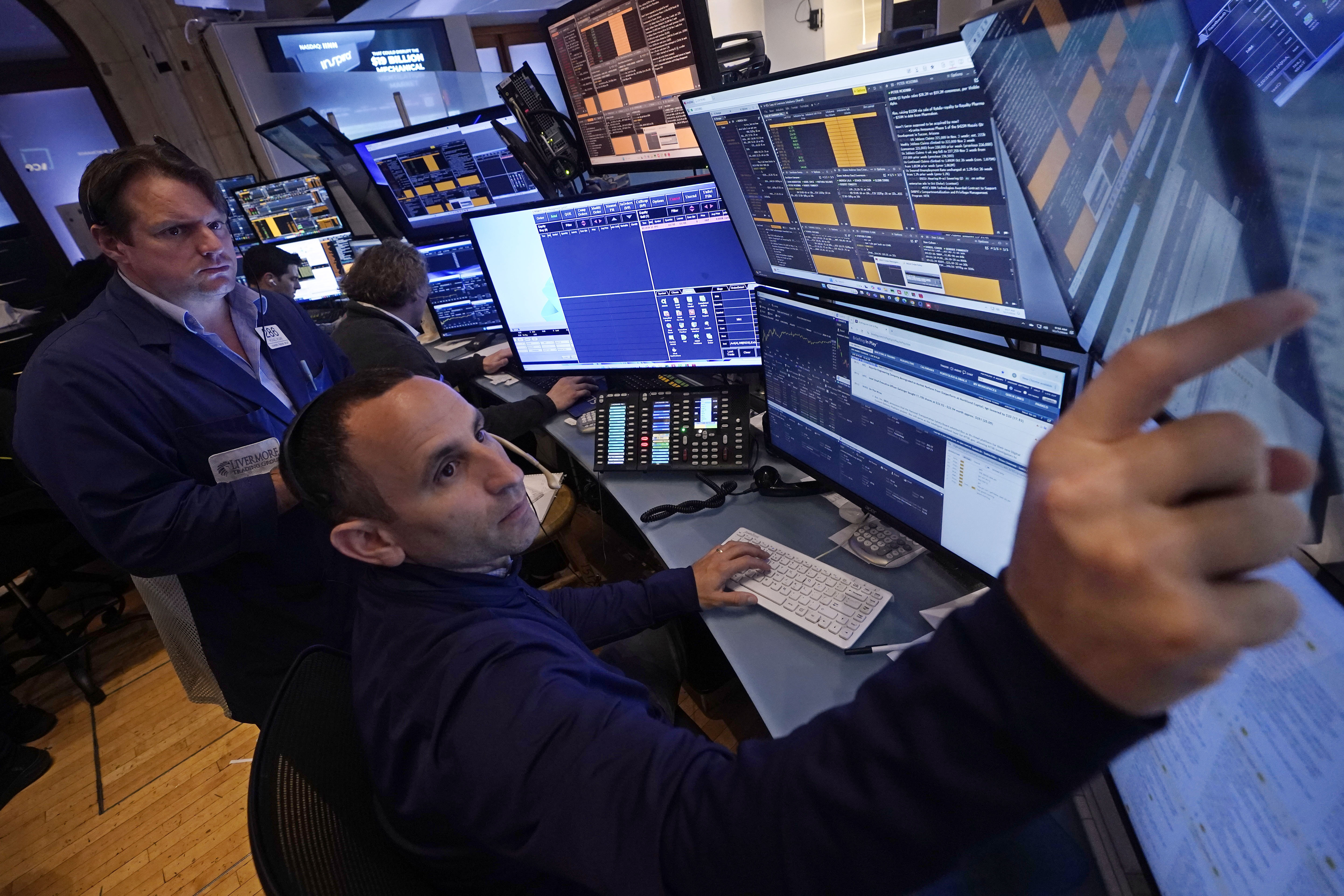 A pair of traders work in their booth on the floor of the New York Stock Exchange, Thursday, Nov. 7, 2024. (AP Photo/Richard Drew)