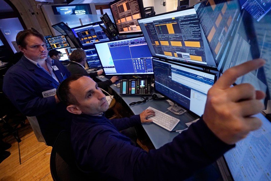 A pair of traders work in their booth on the floor of the New York Stock Exchange, Thursday, Nov. 7, 2024. (AP Photo/Richard Drew)