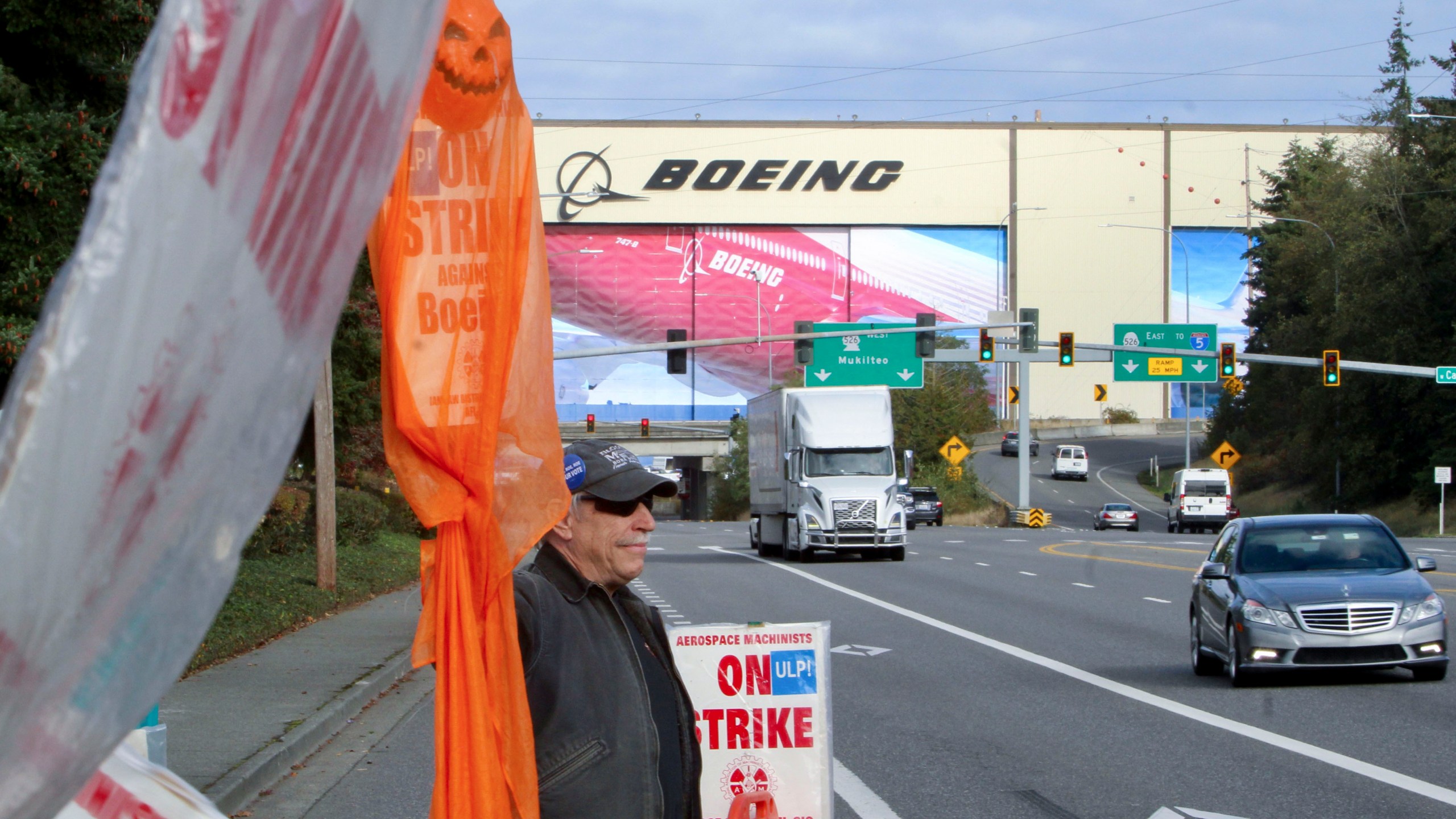 Union machinist Terry Muriekes waves a Halloween-decorated strike sign by Boeing's Everett, Wash., factory on Tuesday, Oct. 22, 2024. (AP Photo/Manuel Valdes)