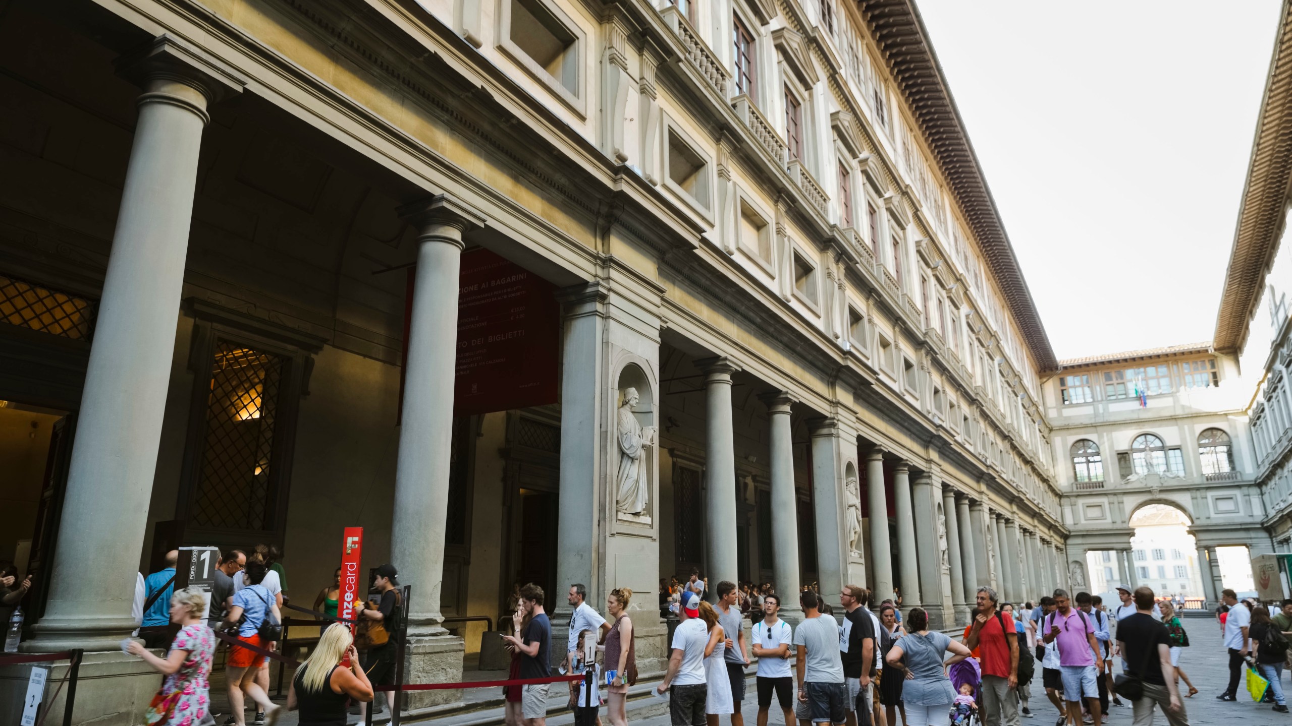 FILE - People line up to enter in the Uffizi Gallery in Florence, Italy, Aug. 1, 2017. (AP Photo/Domenico Stinellis, File)