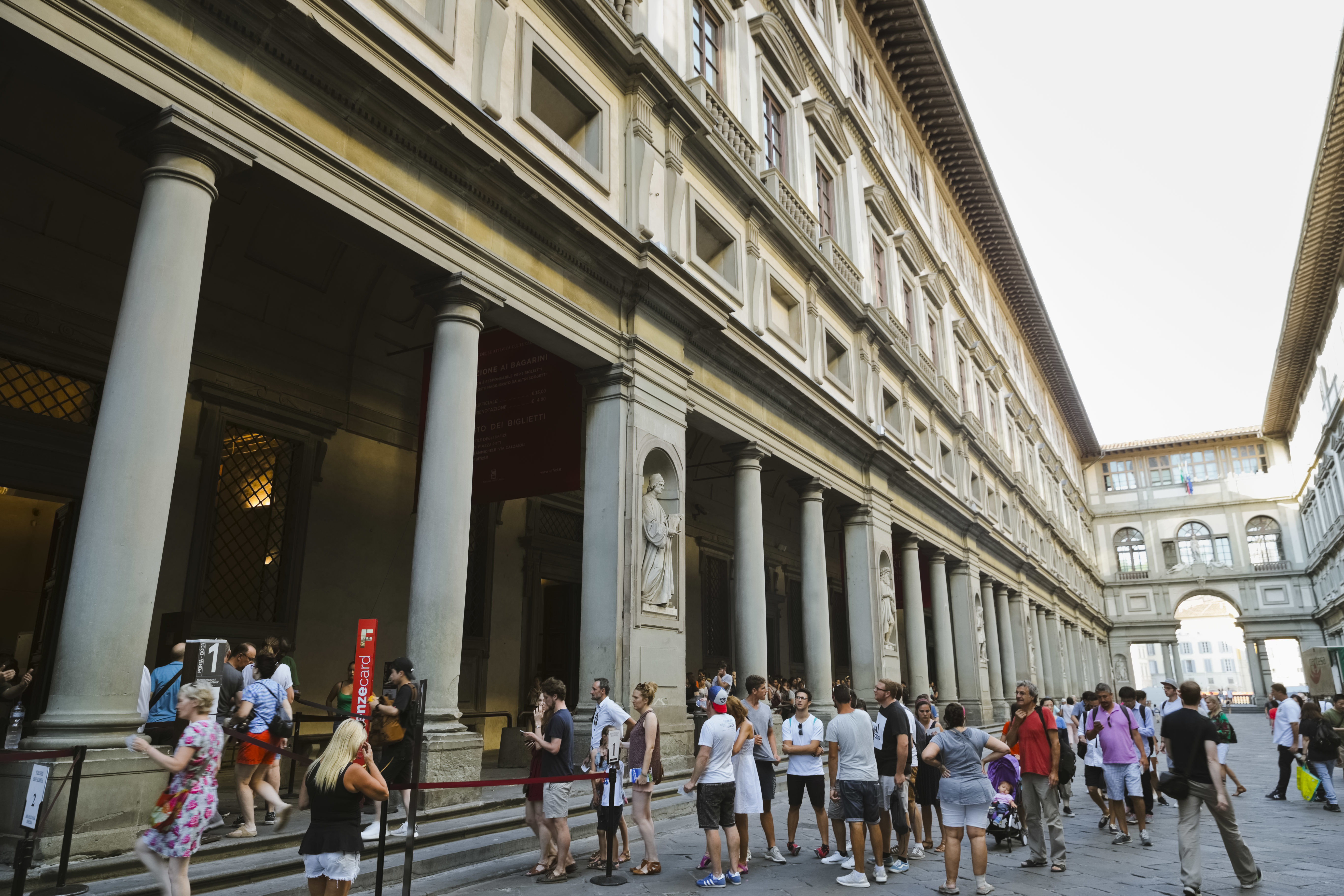 FILE - People line up to enter in the Uffizi Gallery in Florence, Italy, Aug. 1, 2017. (AP Photo/Domenico Stinellis, File)