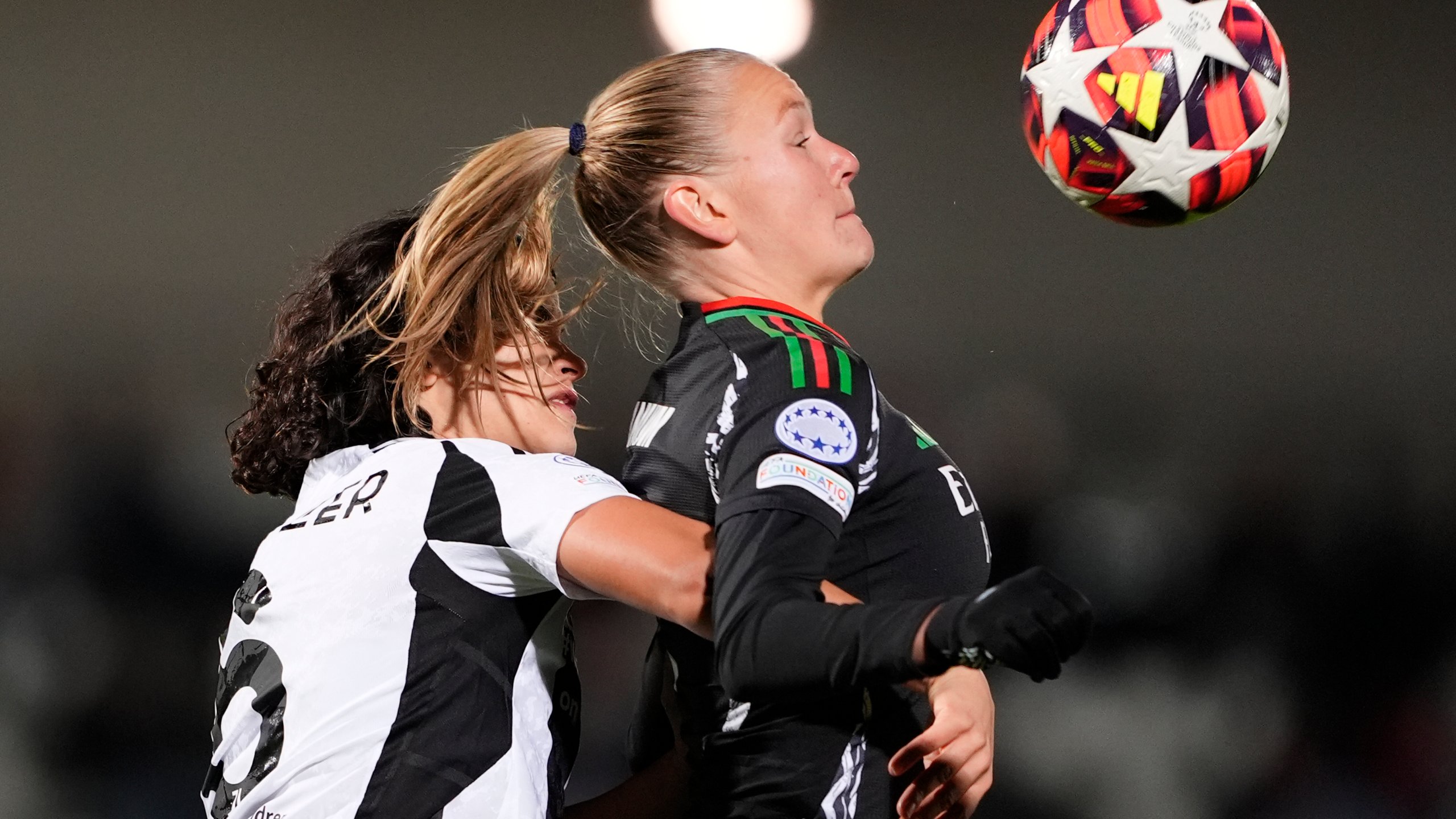 Arsenal's Frida Leonhardsen Maanum, right, and Juventus' Eva Schatzer vie for the ball during the women's Champions League soccer match between Juventus and Arsenal at the Vittorio Pozzo La Marmora Stadium in Biella, Italy, Tuesday, Nov. 12, 2024. (Fabio Ferrari/LaPresse via AP)