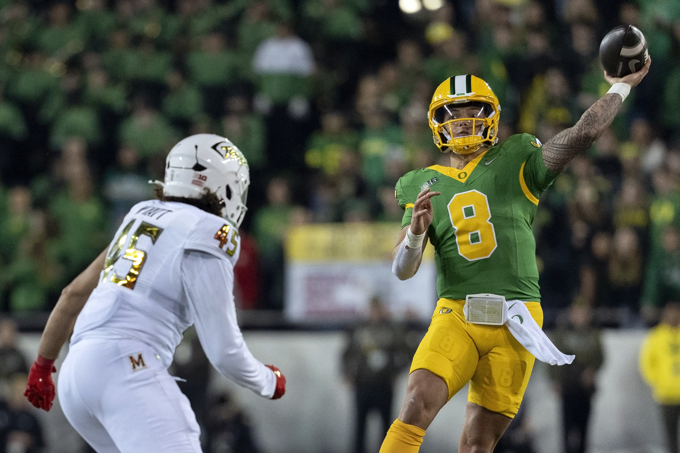 Oregon quarterback Dillon Gabriel (8) throws the ball as Maryland linebacker Kellan Wyatt (45) defends during the second half of an NCAA college football game on Saturday, Nov. 9, 2024, in Eugene, Ore. Oregon won 39-18. (AP Photo/Jenny Kane)